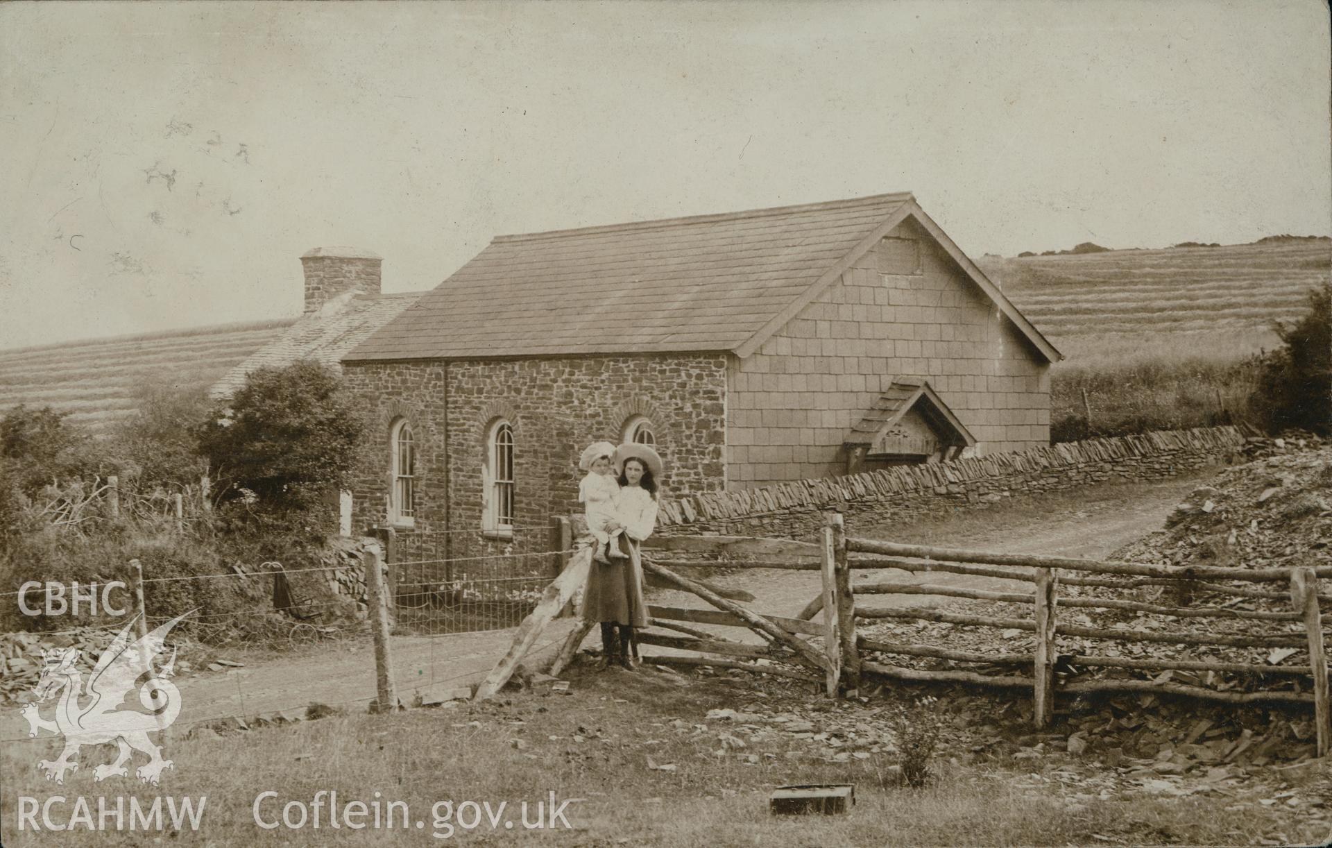 Digital copy of monochrome postcard showing exterior view of Pant Glas Calvinistic Methodist chapel, Pen-Rhiw, Llanilar, with a woman and infant in the foreground. Franked on 14th July 1905. Loaned for copying by Thomas Lloyd.