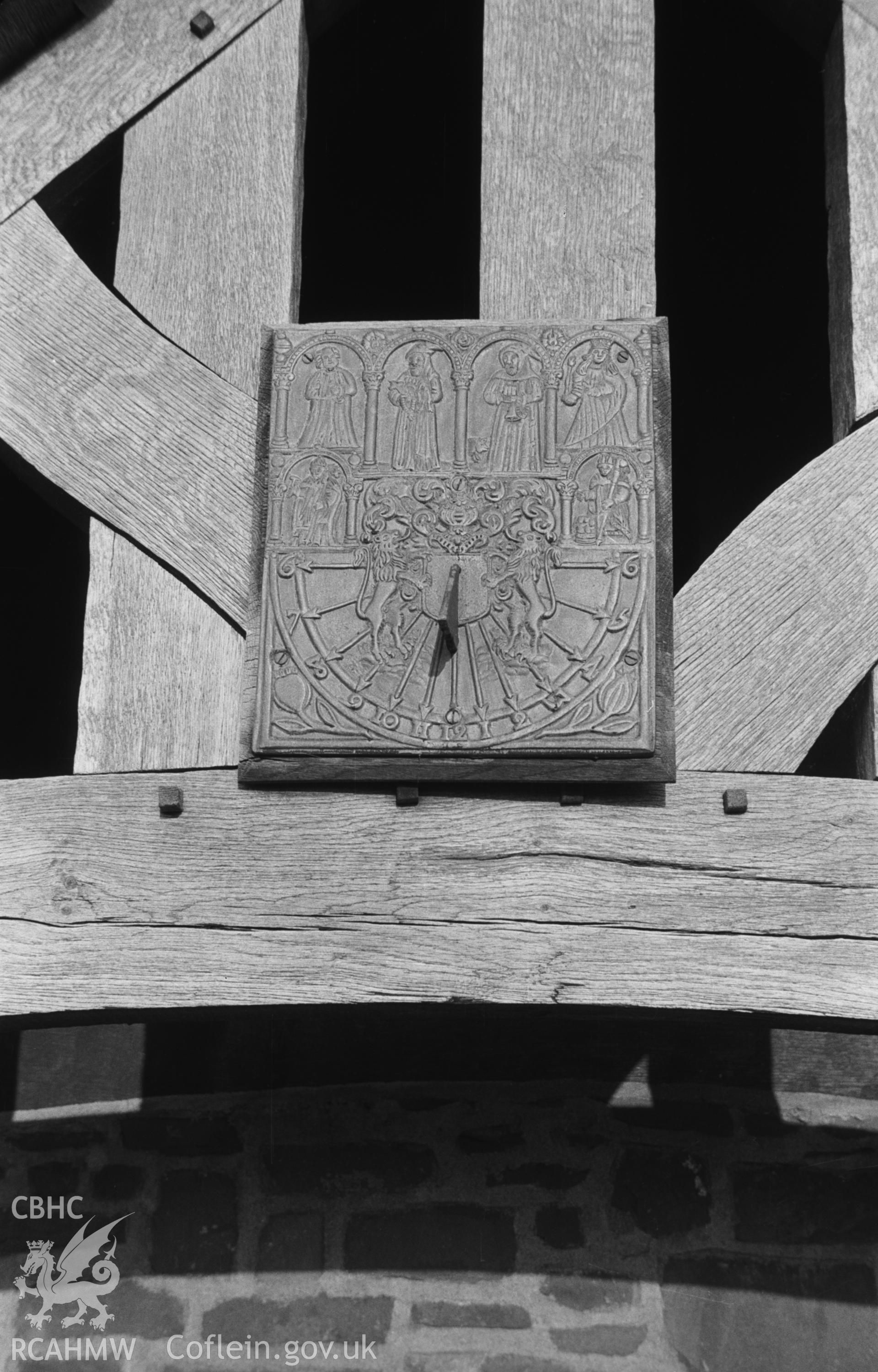 Digital copy of a black and white negative showing sundial on the south side of the churchyard lychgate at St. David's church, Henfynyw. Photographed in December 1963 by Arthur O. Chater from Grid Reference SN 4484 6120, looking north.