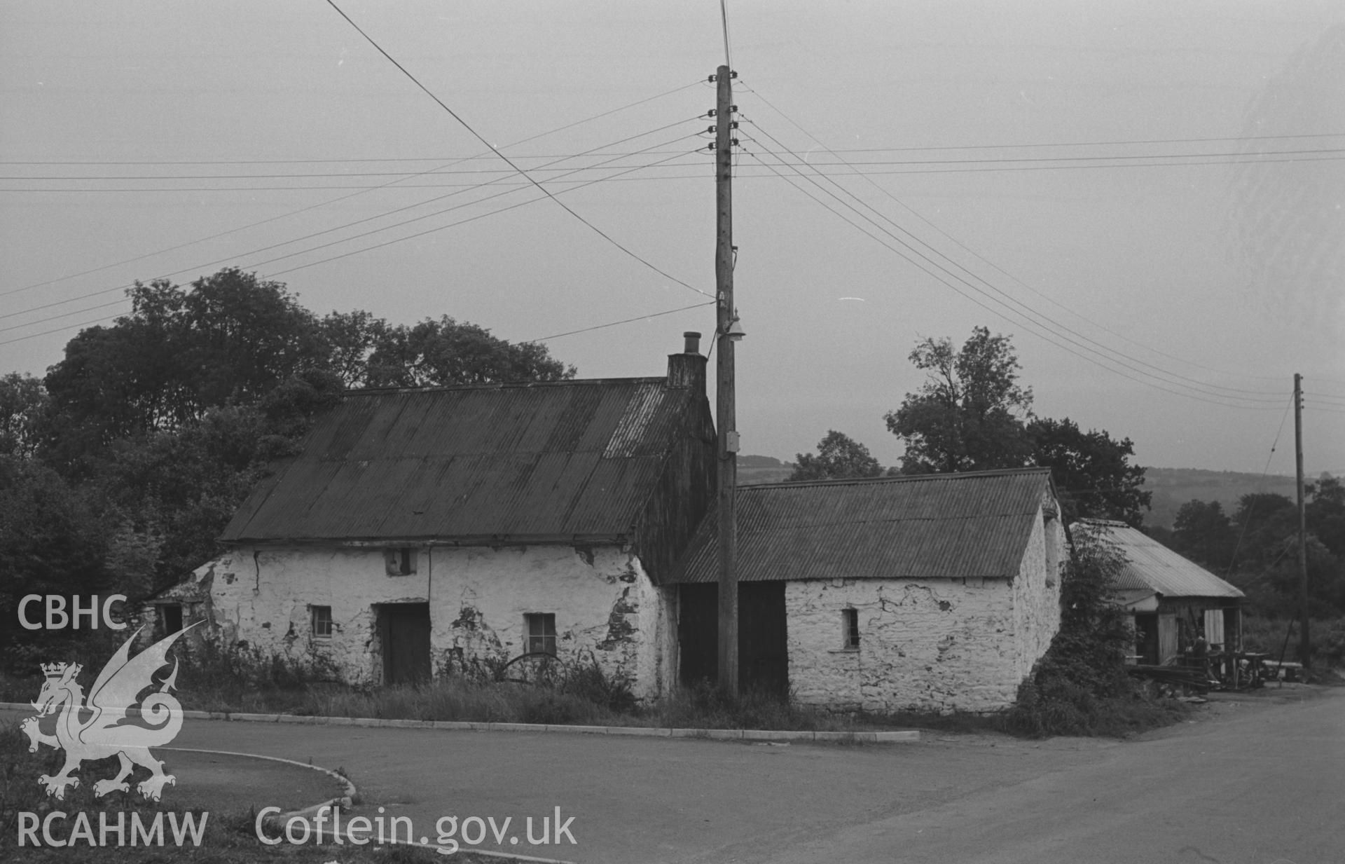 Digital copy of black & white negative showing house on side-lane on east side of the road at Talsarn, near Aberaeron. Forge on extreme right in background. Photograph by Arthur O. Chater, 5th September 1966 looking south from Grid Reference SN 545 563.