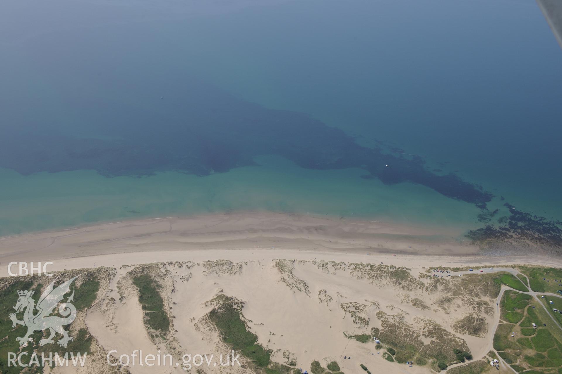 Sarn Padrig Reef and Mochras Spit, off the coast of Llaneddwyn, Dyffryn Ardudwy, Gwynedd. Oblique aerial photograph taken during the Royal Commission?s programme of archaeological aerial reconnaissance by Toby Driver on 12th July 2013.