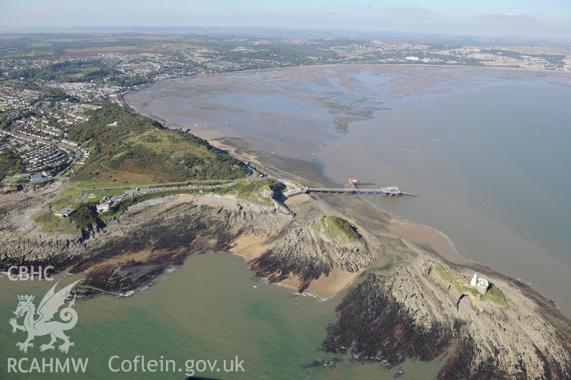 Mumbles fort, pier and lighthouse at the south western edge of Swansea Bay, with Swansea city beyond. Oblique aerial photograph taken during the Royal Commission's programme of archaeological aerial reconnaissance by Toby Driver on 30th September 2015.