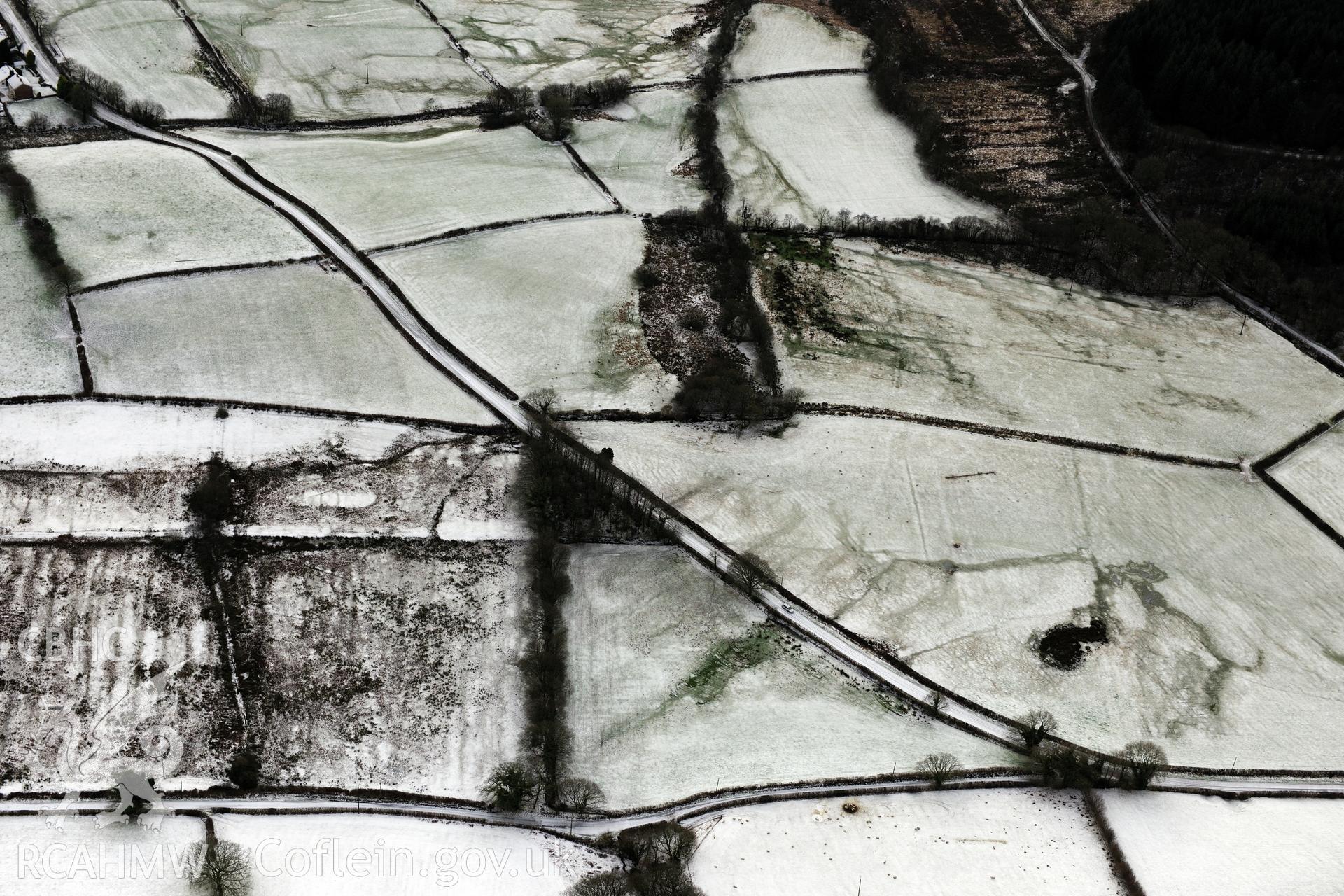 Earthworks of a Roman road, east of Porthyrhyd, north west of Llandovery. Oblique aerial photograph taken during the Royal Commission?s programme of archaeological aerial reconnaissance by Toby Driver on 15th January 2013.