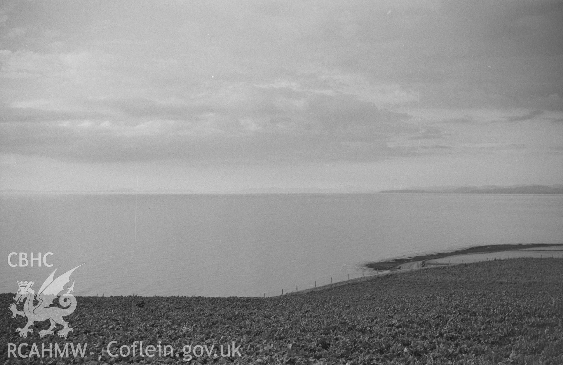 Digital copy of black & white negative showing faint evening panorama of Bardsey island, the Lleyn Peninsula and Cader Idris; Llanon on left. Photographed in August 1963 by Arthur O. Chater from near the highest point of the road to Aberarth (SN 496 650).