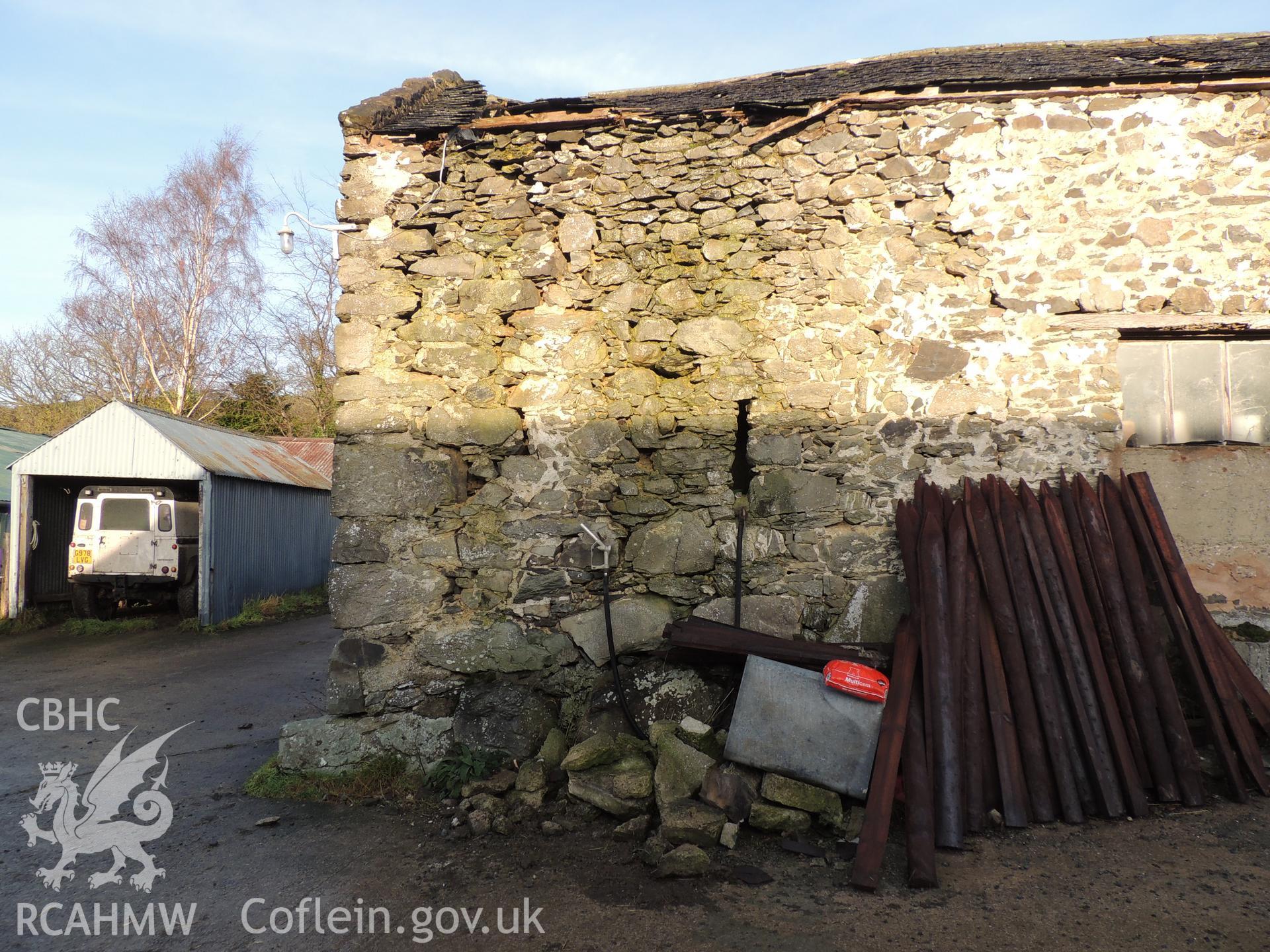 Quoins and ventilation slot, westernmost of front elevation. Photograph taken as part of archaeological building survey at Bryn Gwylan Threshing Barn, Llangernyw, Conwy, carried out by Archaeology Wales, 2017-2018. Report no. 1640. Project no. 2578.