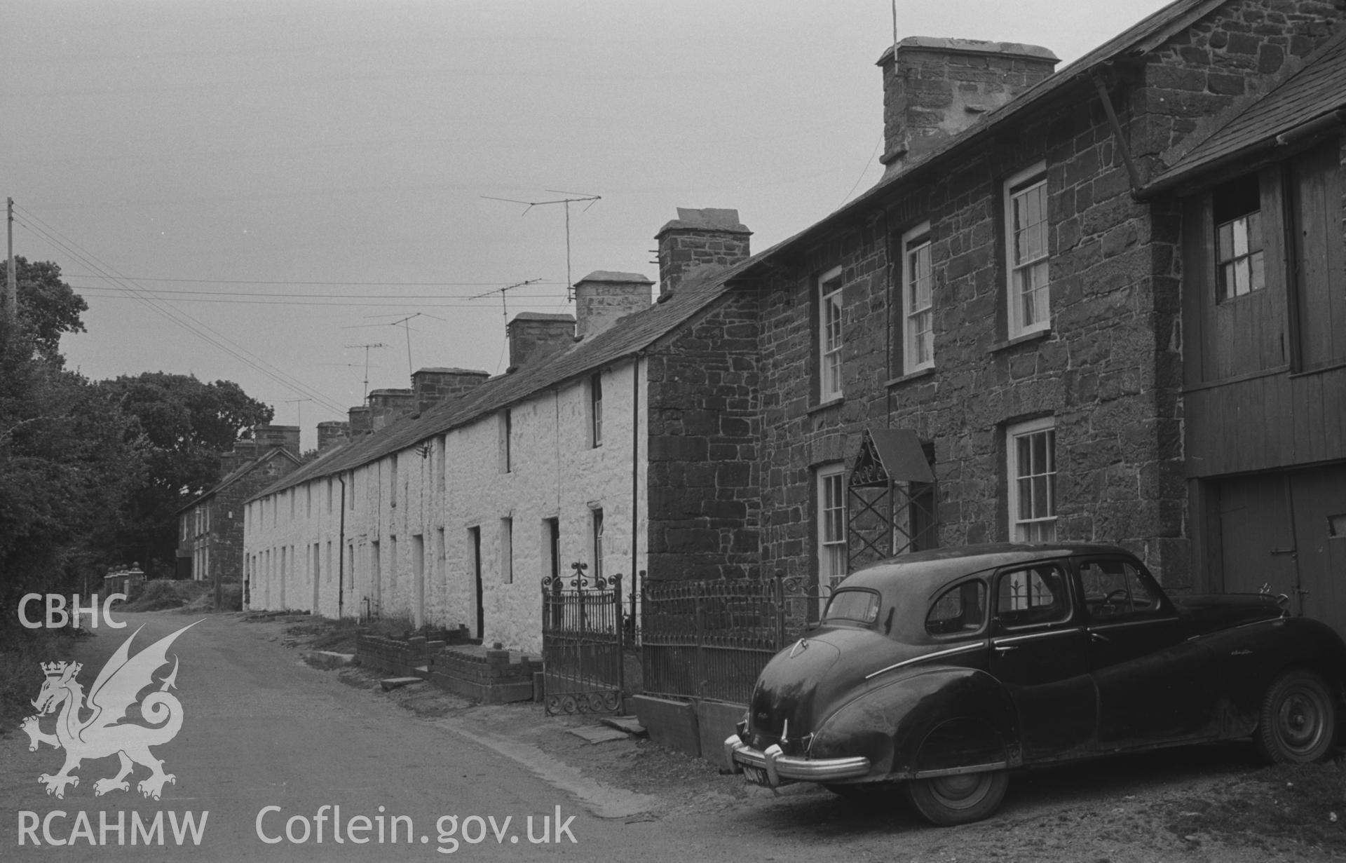 Digital copy of a black and white negative showing cottages and car on Cwmsaeson Road at Oakford, Aberaeron. Photographed by Arthur O. Chater on 5th September 1966 looking north east from the crossroads at SN 452 580.