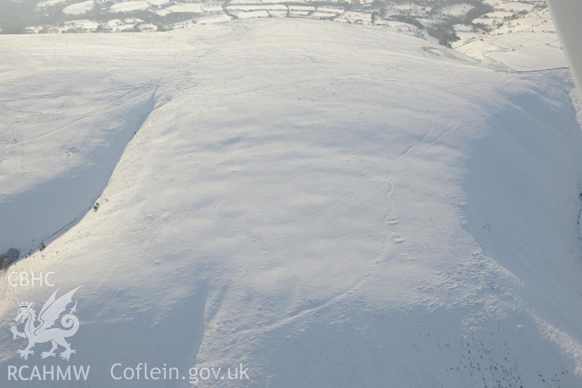 Mynydd-y-Gaer building platforms, north east of Bridgend. Oblique aerial photograph taken during the Royal Commission?s programme of archaeological aerial reconnaissance by Toby Driver on 24th January 2013.