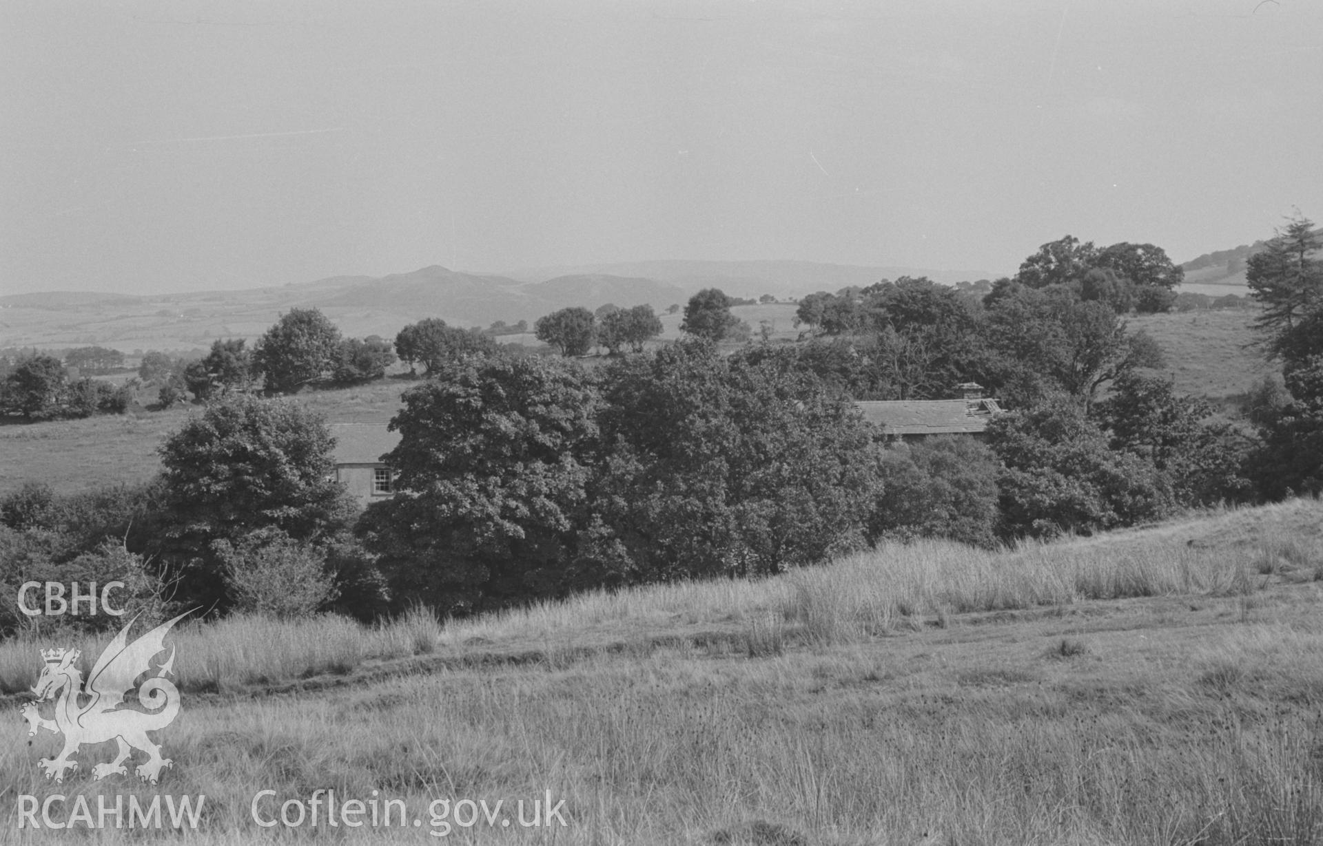 Digital copy of a black and white negative showing view looking across the Afon Fflur to Felin Fflur (in trees to left); Pen y Bannau in distance. Photographed by Arthur O. Chater in August 1967. (Looking north north east from Grid Reference SN 7200 6425).