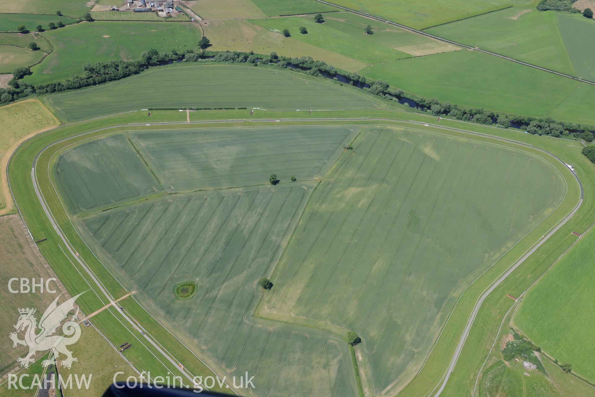 Enclosure at Bangor Racecourse, south east of Wrexham. Oblique aerial photograph taken during the Royal Commission's programme of archaeological aerial reconnaissance by Toby Driver on 30th June 2015.