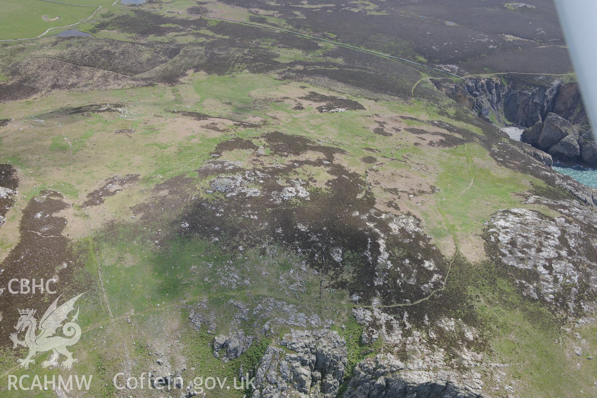 Carn Llundain and its relict field walls on Ramsey Island. Oblique aerial photograph taken during the Royal Commission's programme of archaeological aerial reconnaissance by Toby Driver on 13th May 2015.