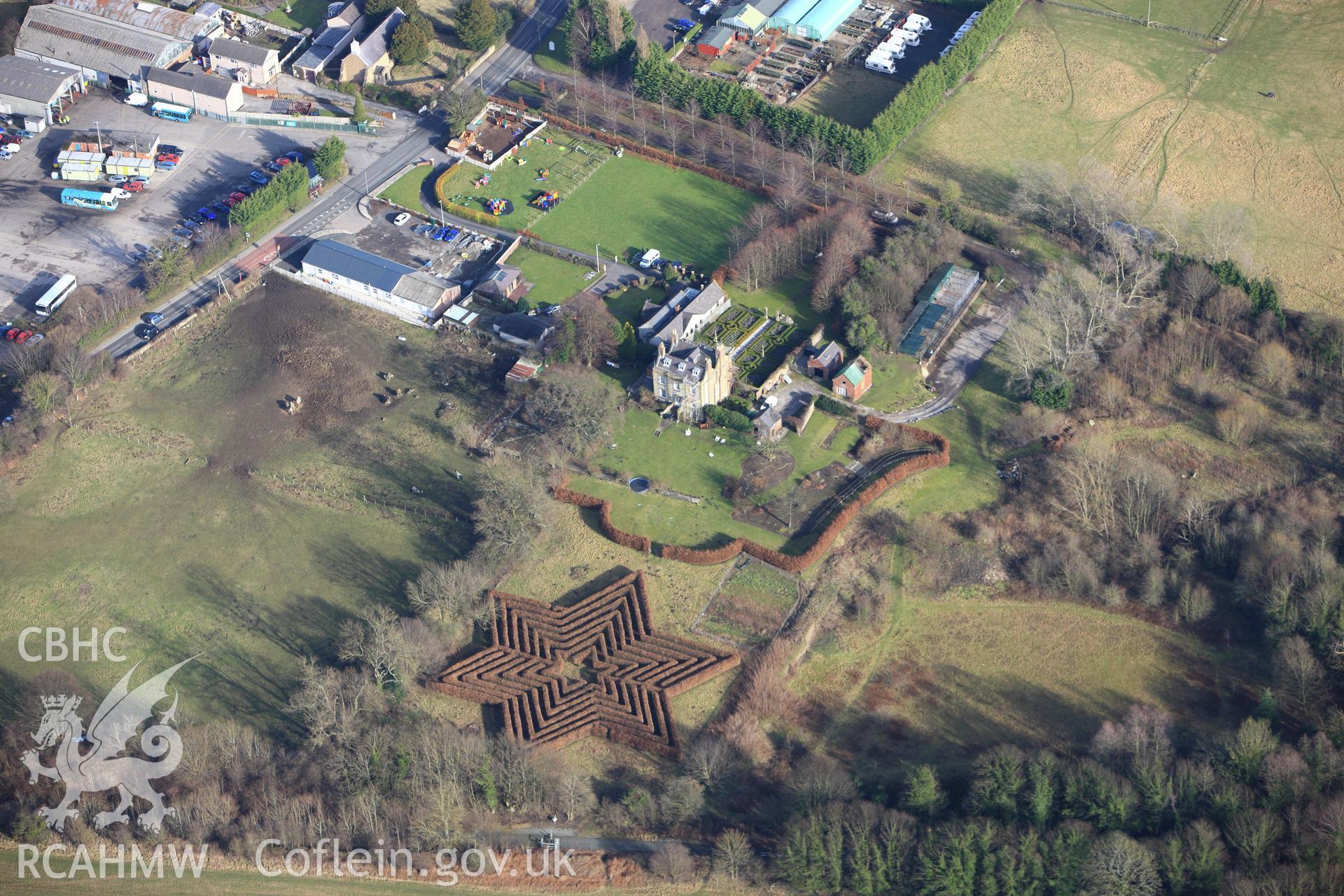 RCAHMW colour oblique photograph of Berse Drelincourt, vicarage, showing a maze to the west of the property. Taken by Toby Driver on 08/02/2011.
