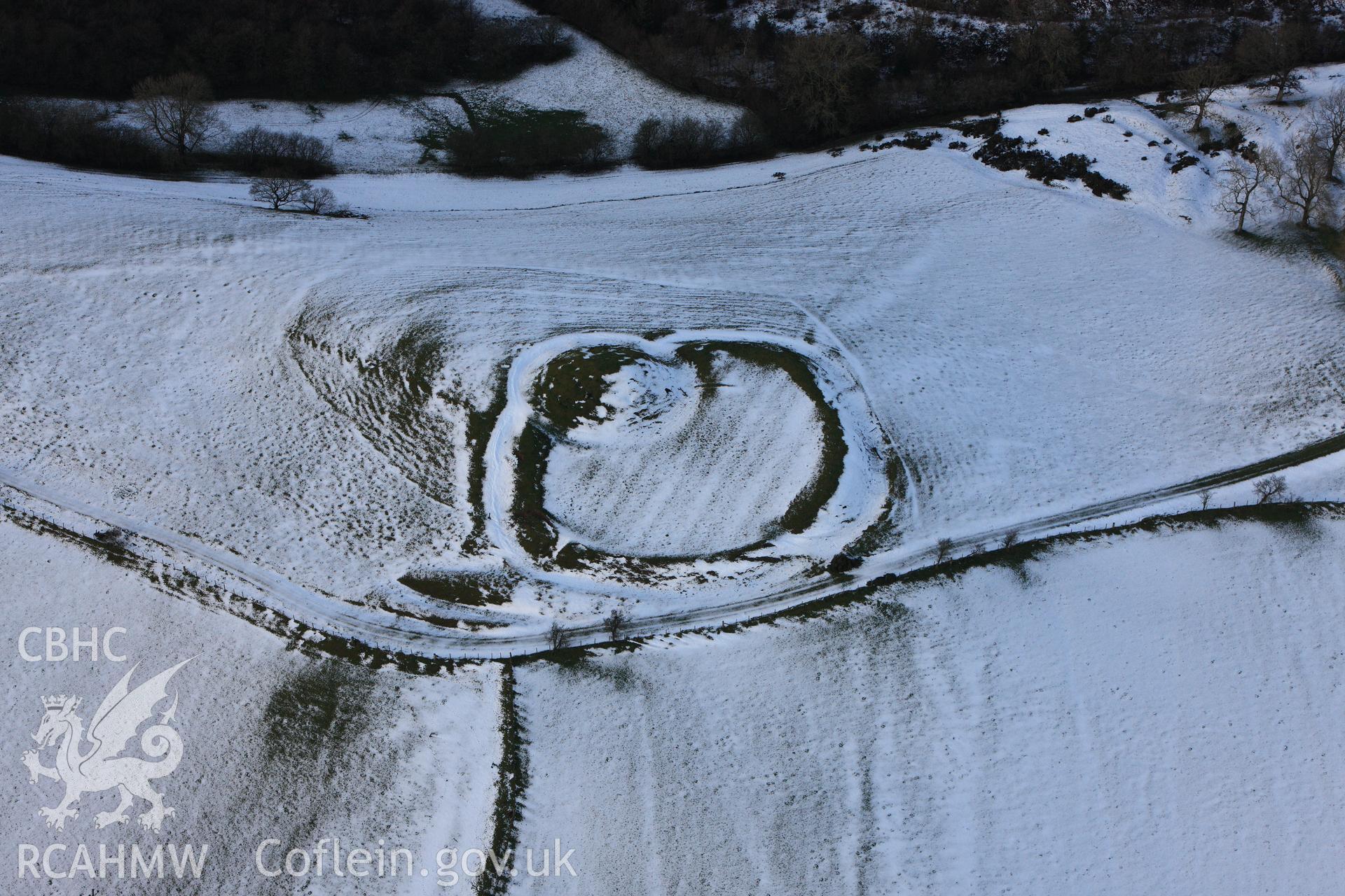 RCAHMW colour oblique photograph of Castell Crugerydd, motte and bailey under snow. Taken by Toby Driver on 18/12/2011.