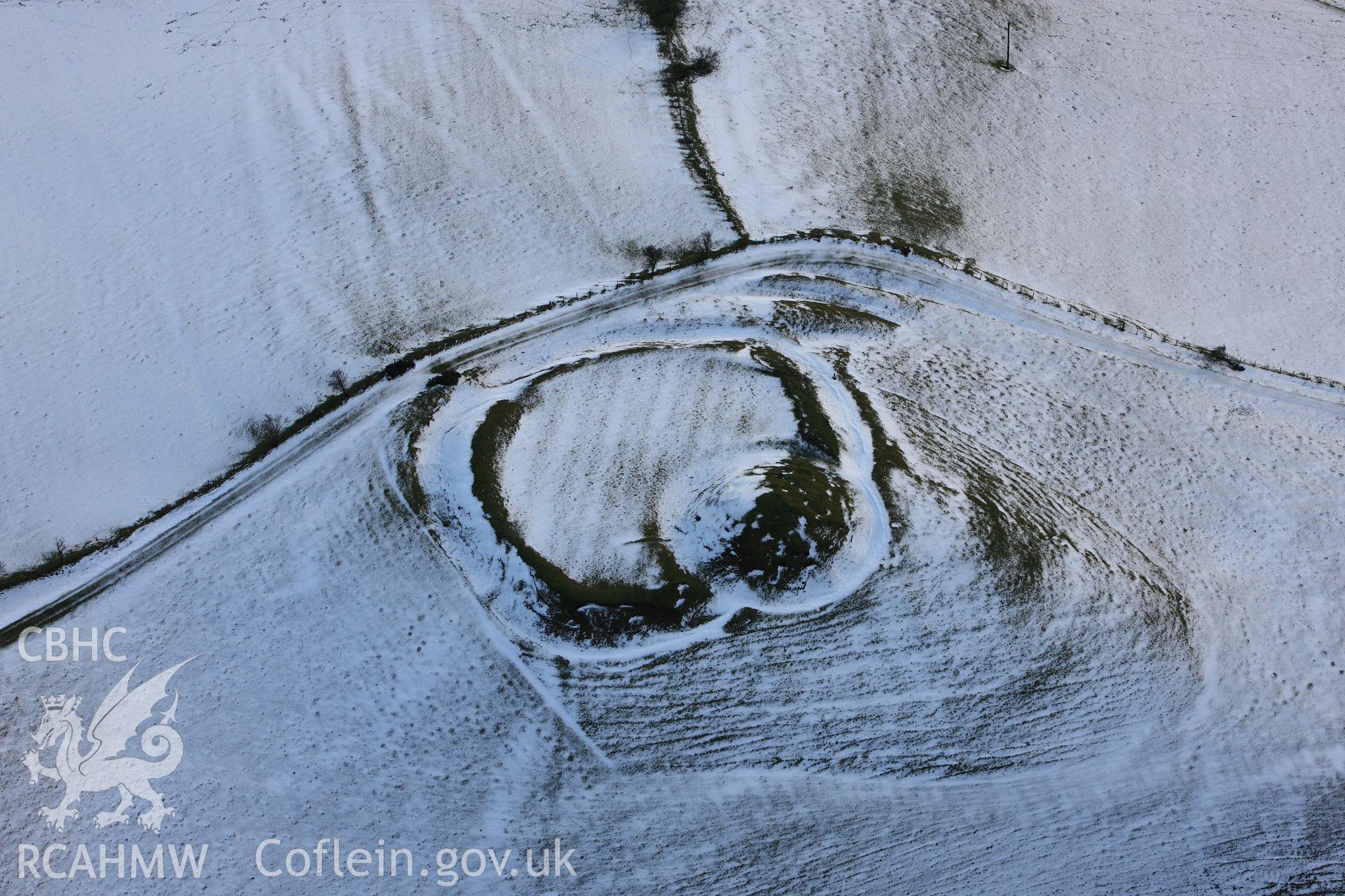 RCAHMW colour oblique photograph of Castell Crugerydd, motte and bailey under snow. Taken by Toby Driver on 18/12/2011.