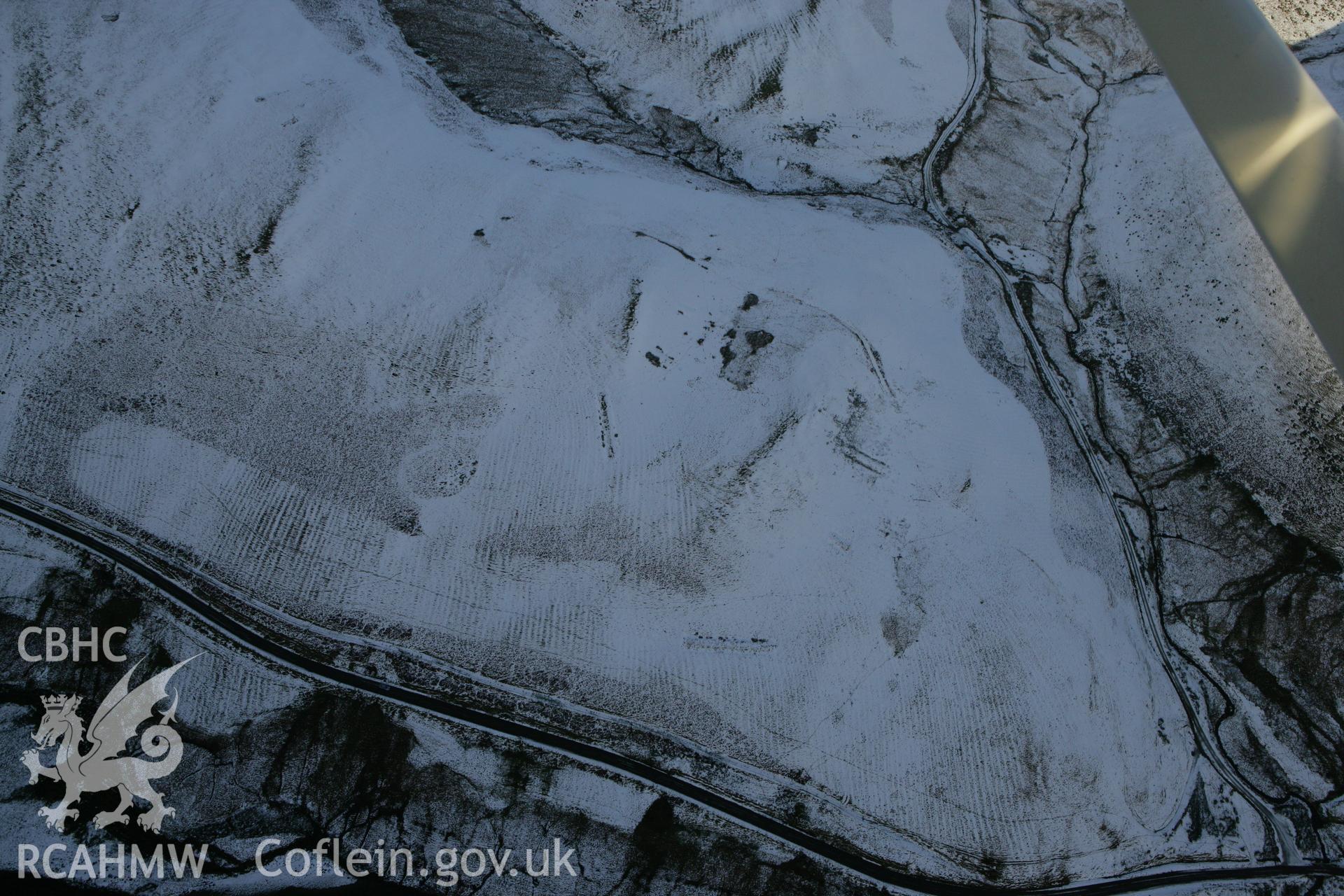 RCAHMW colour oblique photograph of Esgair yu Ty rabbit warren, view from south-west under snow and cloud shadow. Taken by Toby Driver on 18/12/2011.