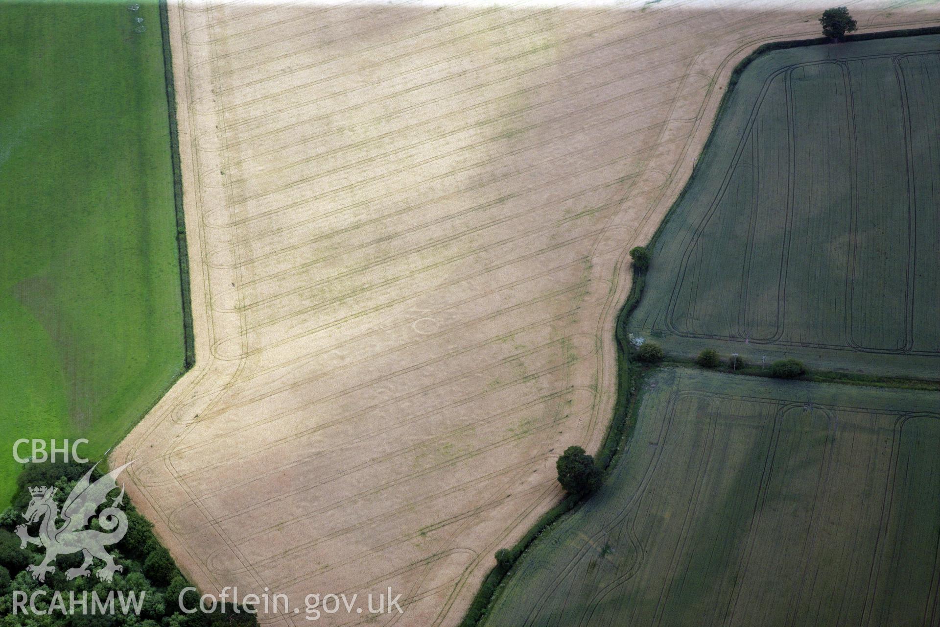 RCAHMW colour oblique photograph of Gerwyn-Fechan round barrow and other cropmarks. Taken by Toby Driver and Oliver Davies on 05/07/2011.
