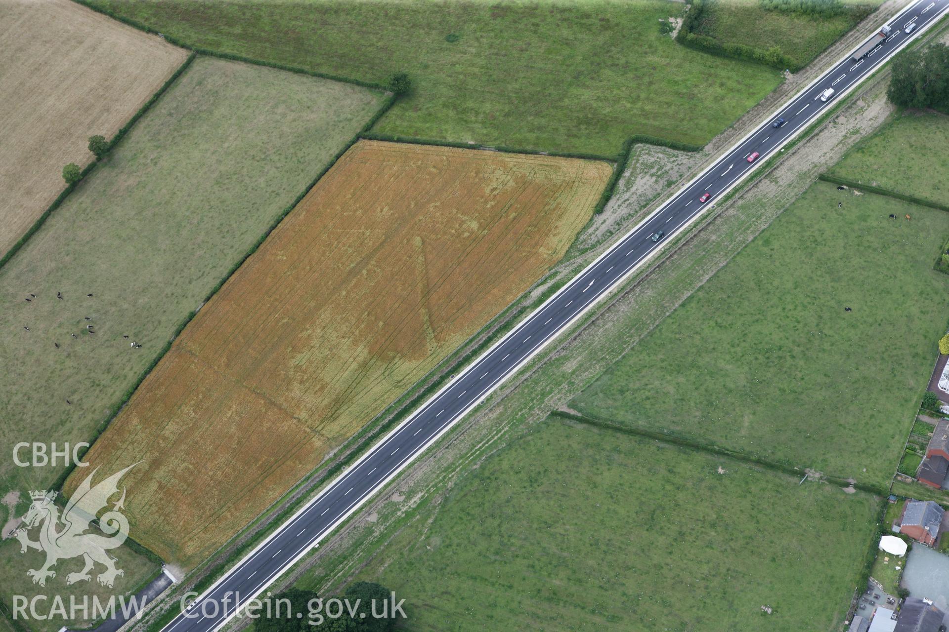 RCAHMW colour oblique photograph of Four Crosses bypass, cropmark of ditch. Taken by Toby Driver on 20/07/2011.