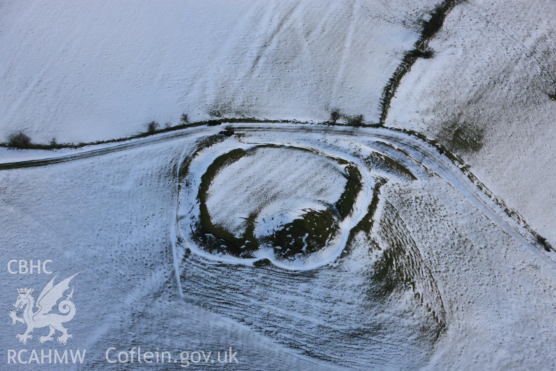 RCAHMW colour oblique photograph of Castell Crugerydd, motte and bailey under snow. Taken by Toby Driver on 18/12/2011.