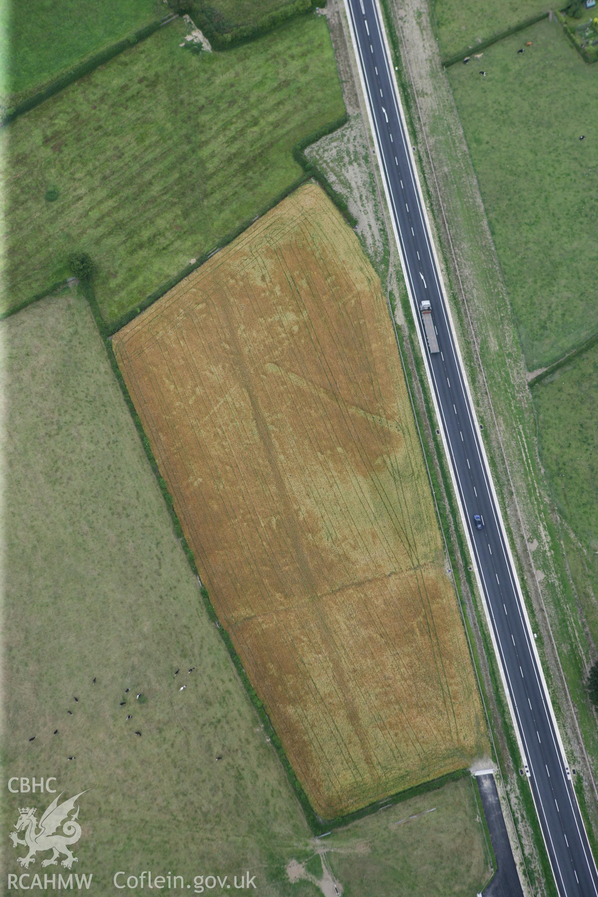 RCAHMW colour oblique photograph of Four Crosses bypass, cropmark of ditch. Taken by Toby Driver on 20/07/2011.
