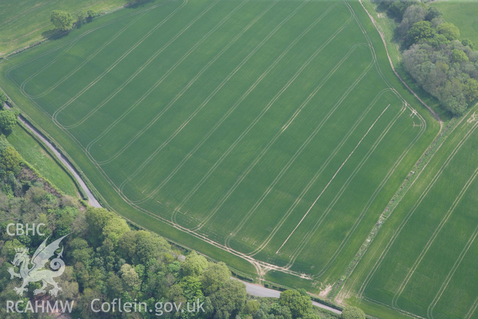 RCAHMW colour oblique photograph of Malthouse Road defended enclosure, cropmark. Taken by Toby Driver on 26/04/2011.