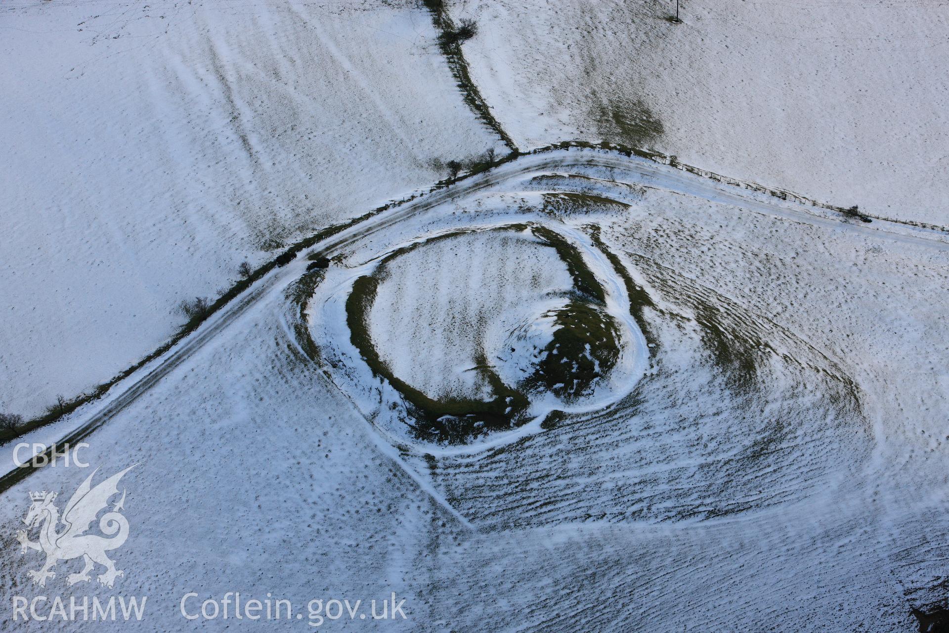 RCAHMW colour oblique photograph of Castell Crugerydd, motte and bailey under snow. Taken by Toby Driver on 18/12/2011.