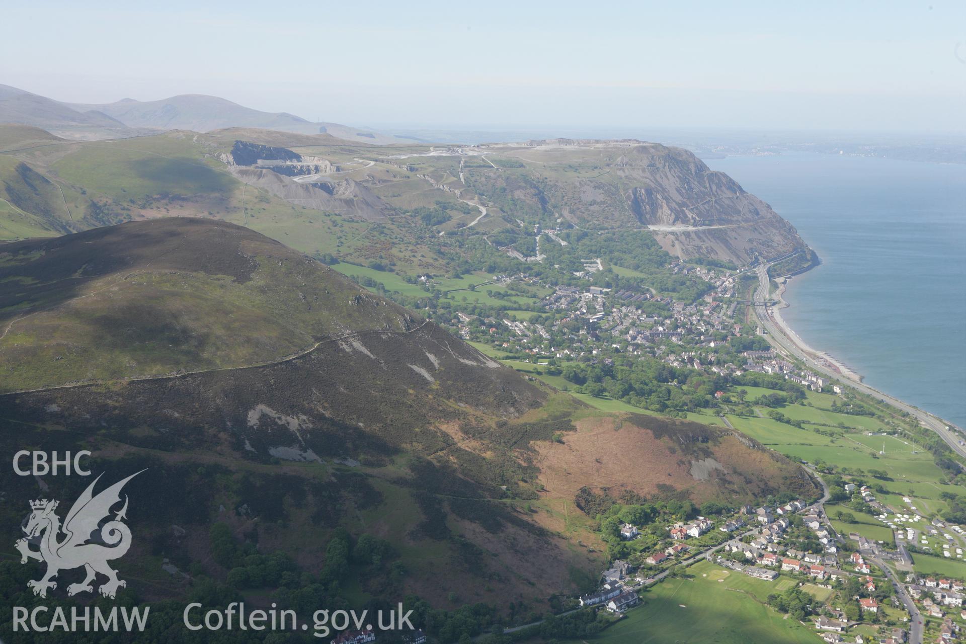 RCAHMW colour oblique photograph of landscape looking west towards Penmaenmawr Granite Quarry, from Dwygyfylchi. Taken by Toby Driver on 03/05/2011.