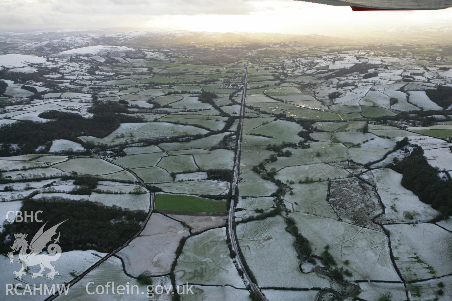 RCAHMW colour oblique photograph of Central Wales line, looking south-west over Dolau. Taken by Toby Driver on 18/12/2011.