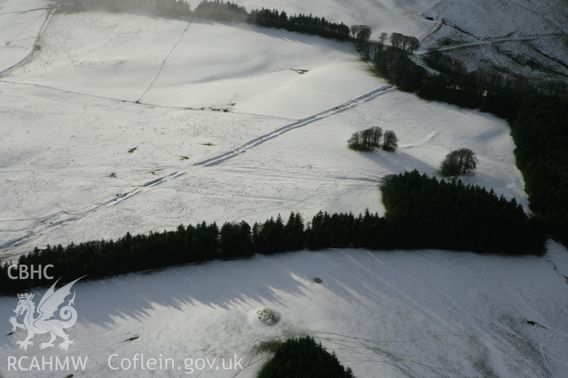 RCAHMW colour oblique photograph of Crugyn Bank, under snow, with round barrows. Taken by Toby Driver on 18/12/2011.