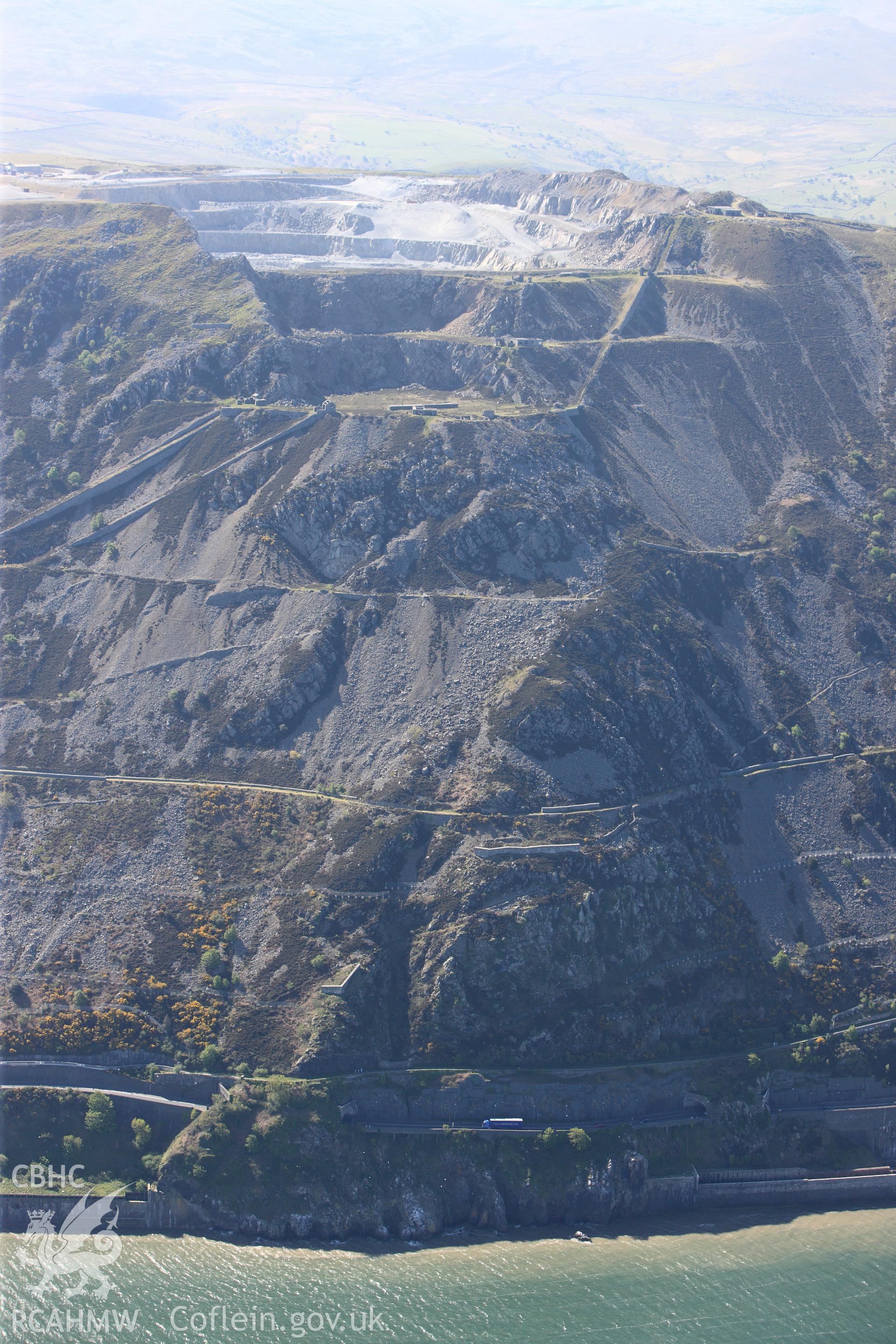 RCAHMW colour oblique photograph of Penmaenmawr Granite Quarry. Taken by Toby Driver on 03/05/2011.