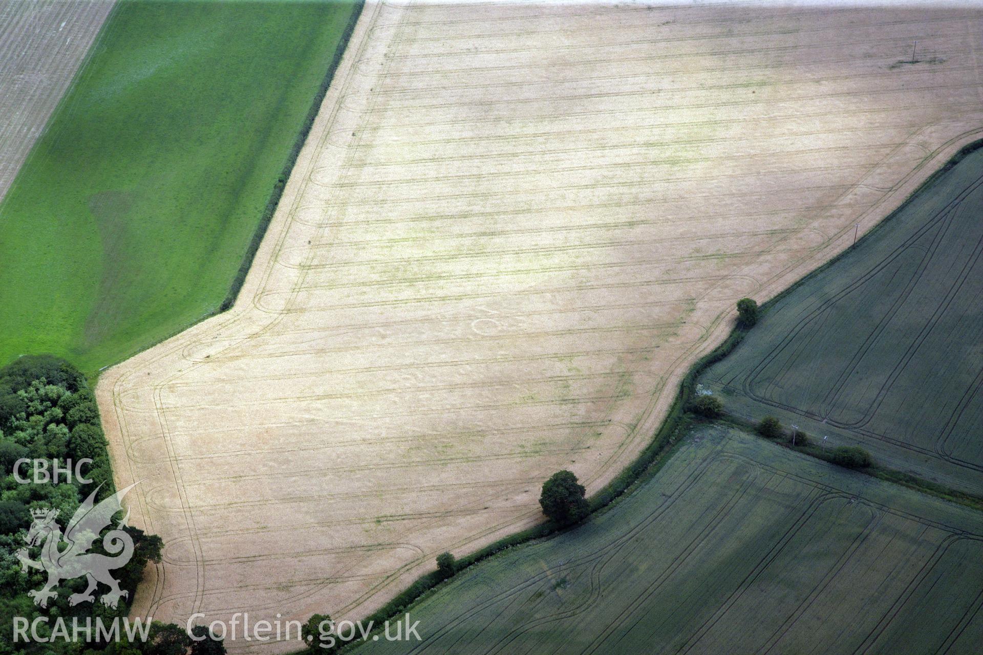 RCAHMW colour oblique photograph of Gerwyn-Fechan round barrow and other cropmarks. Taken by Toby Driver and Oliver Davies on 05/07/2011.