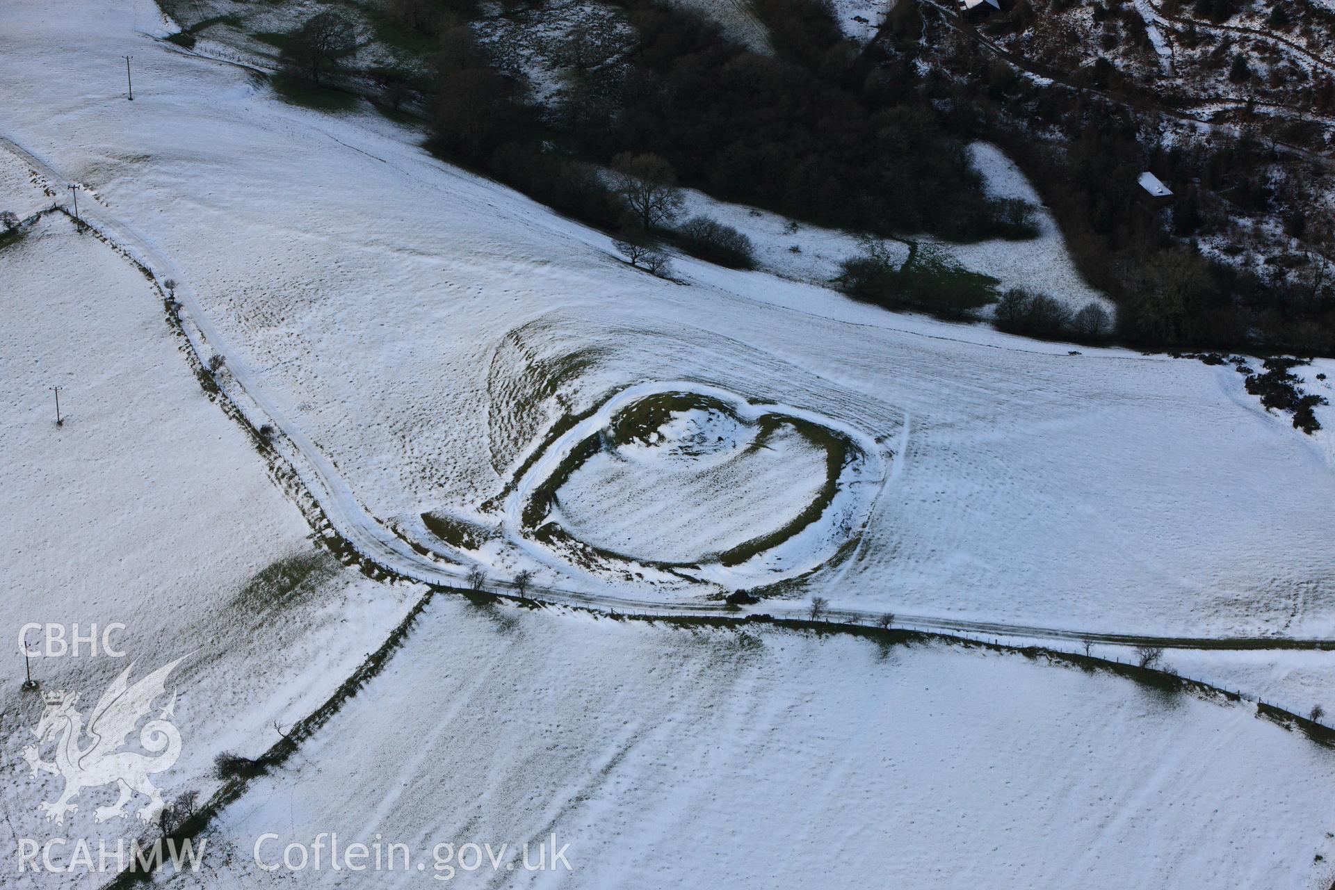 RCAHMW colour oblique photograph of Castell Crugerydd, motte and bailey under snow. Taken by Toby Driver on 18/12/2011.