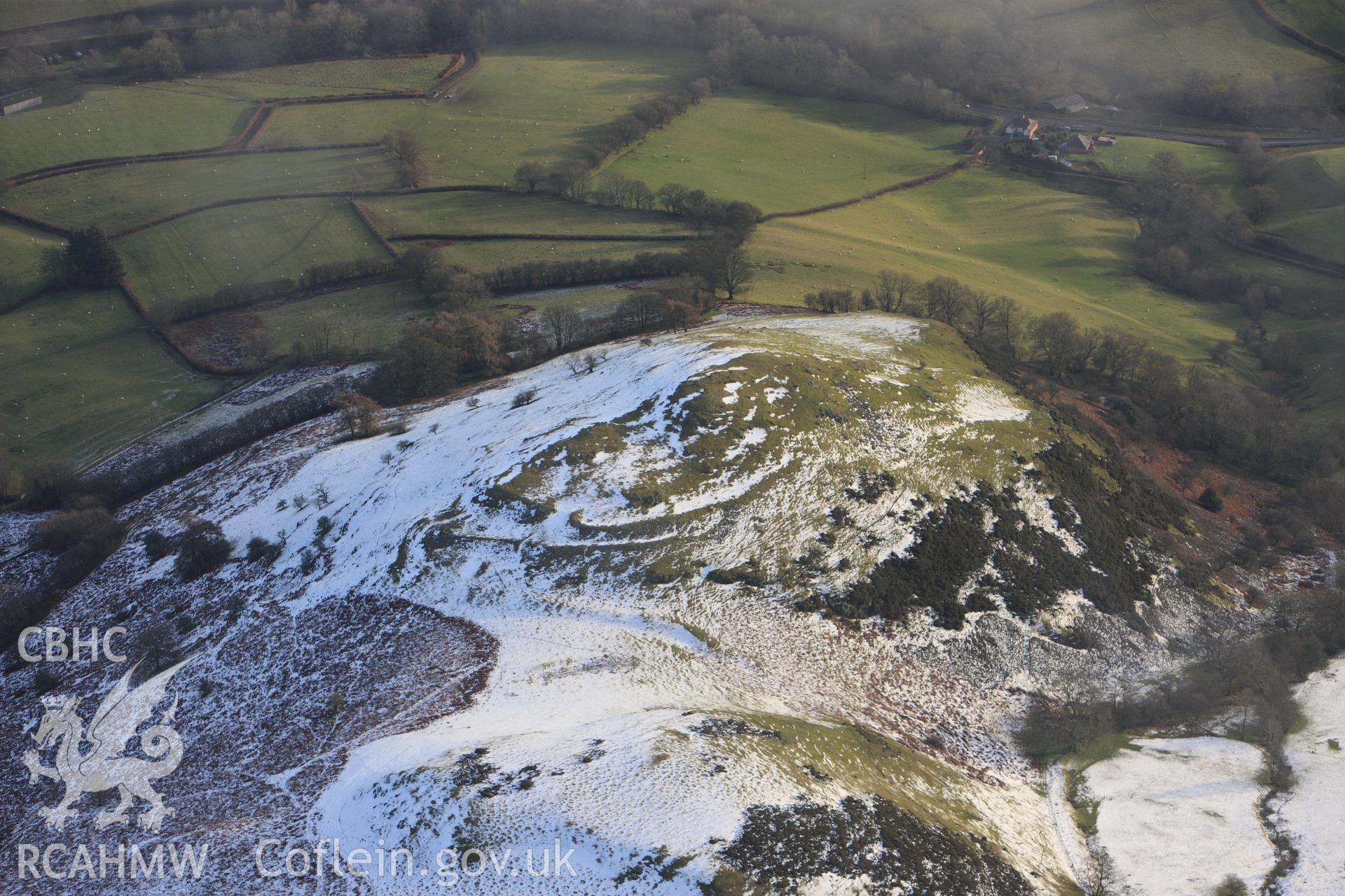 RCAHMW colour oblique photograph of Caer Einion hillfort, with melting snow. Taken by Toby Driver on 18/12/2011.