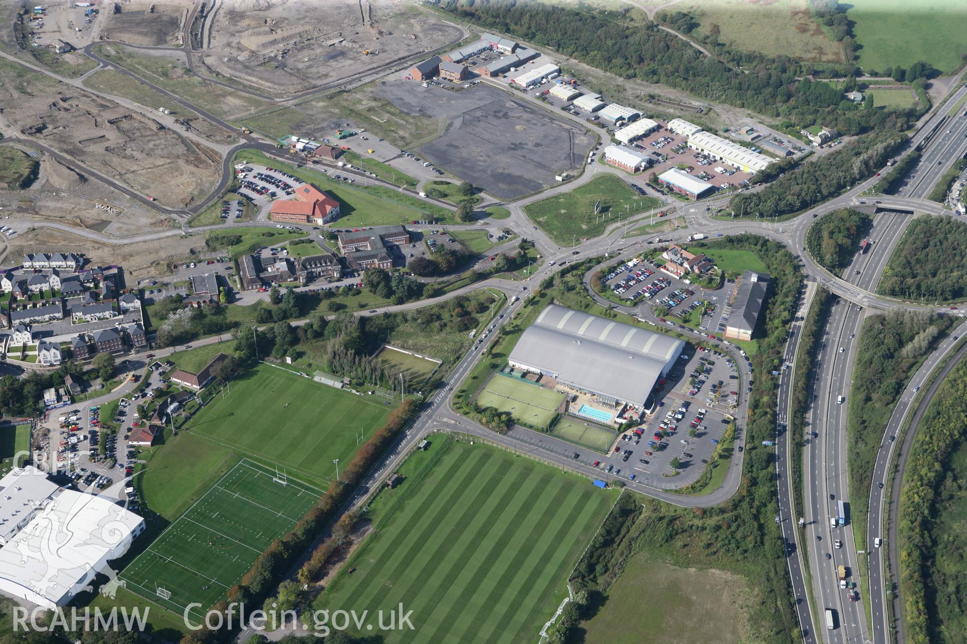 RCAHMW colour oblique photograph of Landarcy Acadamy of Sport with Llandarcy oil refinery to the north-west,. Taken by Toby Driver and Oliver Davies on 28/09/2011.