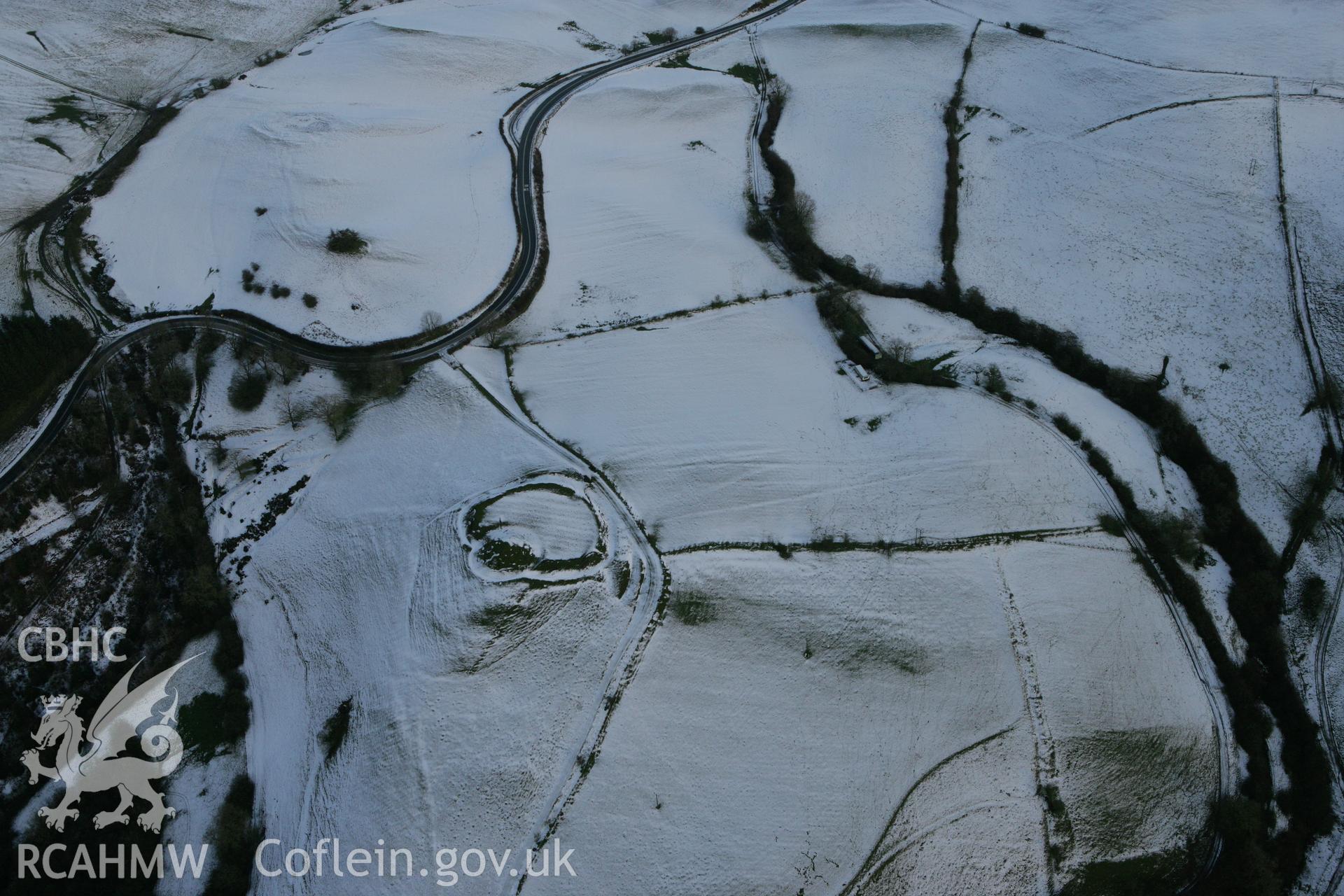 RCAHMW colour oblique photograph of Castell Crugerydd, motte and bailey under snow. Taken by Toby Driver on 18/12/2011.