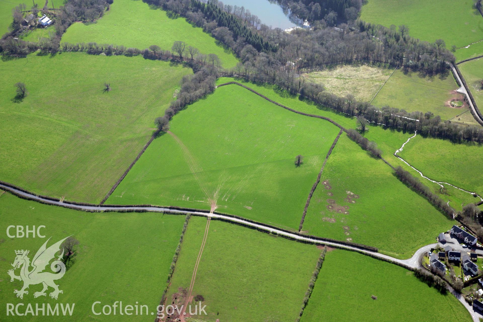 RCAHMW colour oblique photograph of Cradoc Station standing stone, line of gas pipeline crossing fields to the north of. Taken by Toby Driver and Oliver Davies on 28/03/2012.