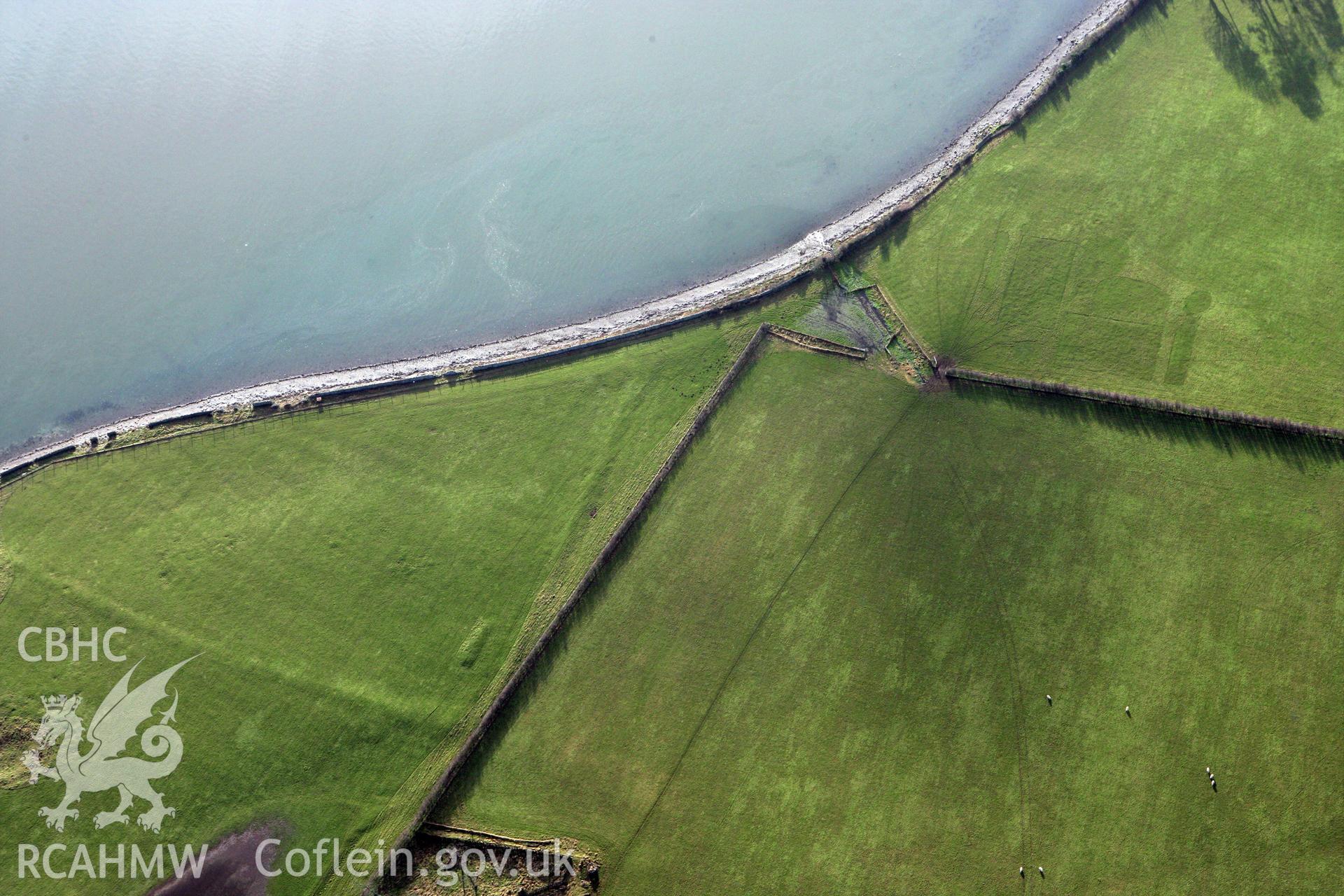 RCAHMW colour oblique photograph of Tai Cochion Roman settlement, site of backfilled excavation trenches, and earthwork long mound. Taken by Toby Driver on 13/01/2012.
