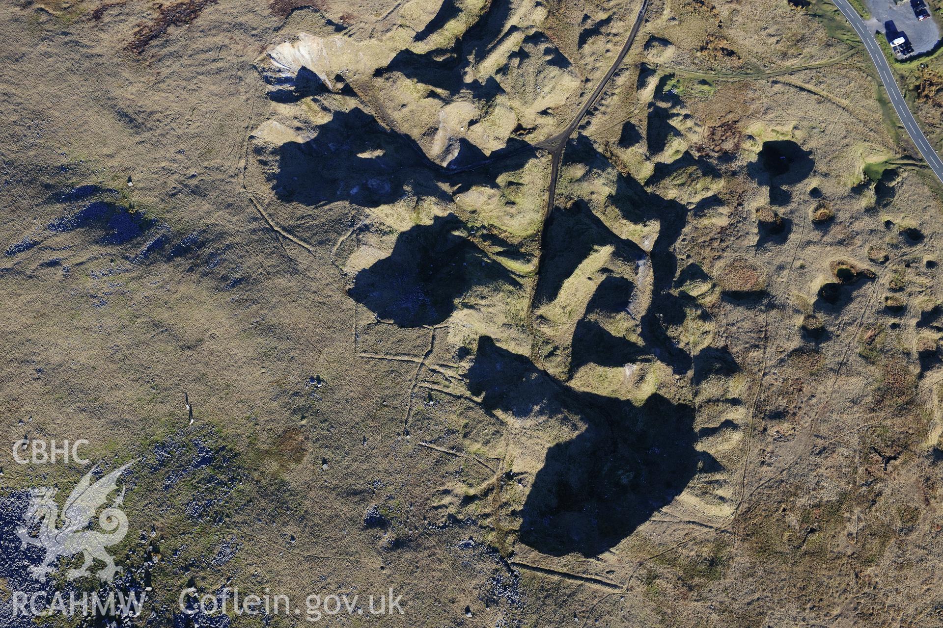 RCAHMW colour oblique photograph of Foel Fawr quarry complex, bank of quarries with feeder leats. Taken by Toby Driver on 28/11/2012.