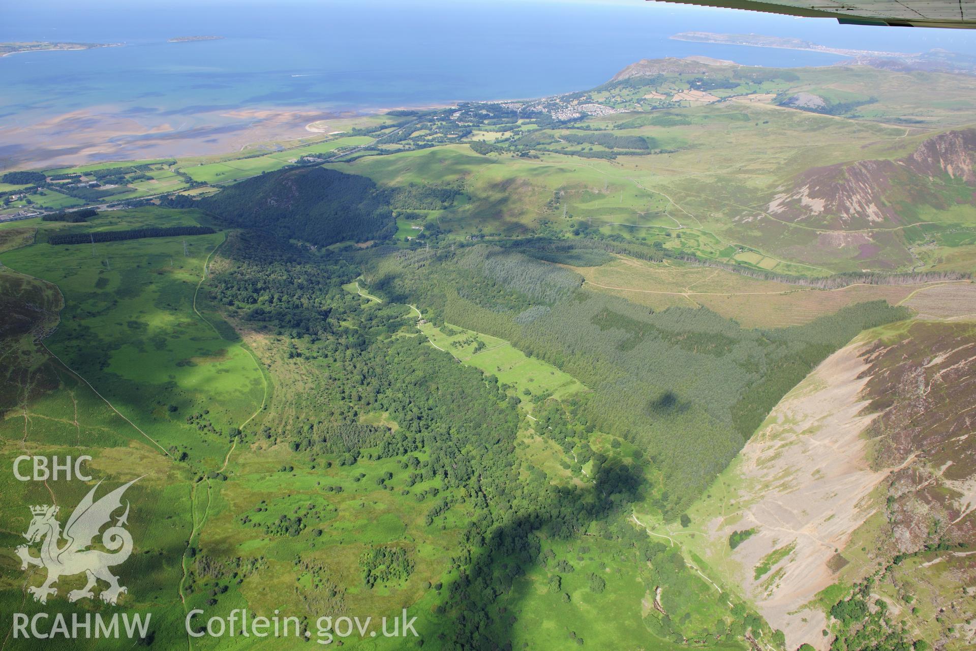 RCAHMW colour oblique photograph of Coedydd Aber National Nature Reserve, landscape view. Taken by Toby Driver on 10/08/2012.