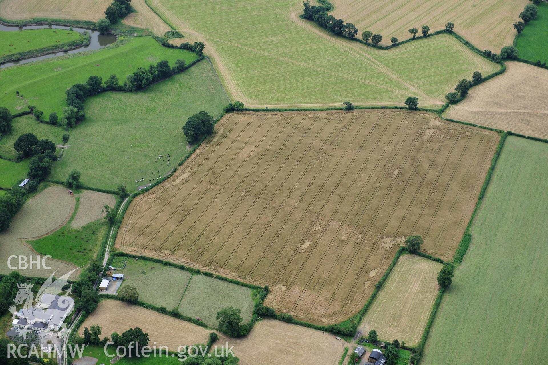RCAHMW colour oblique photograph of Llandrinio Prehistoric Village, cropmarks. Taken by Toby Driver on 27/07/2012.