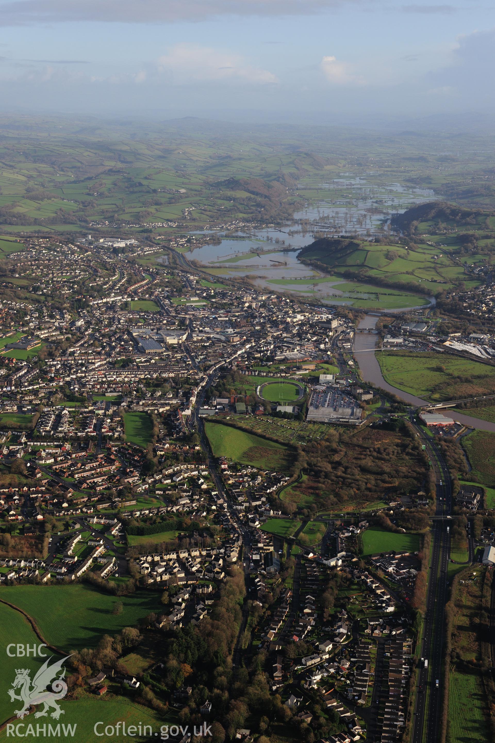 RCAHMW colour oblique photograph of Carmarthen townscape, looking east with flooding on the Tywi. Taken by Toby Driver on 23/11/2012.