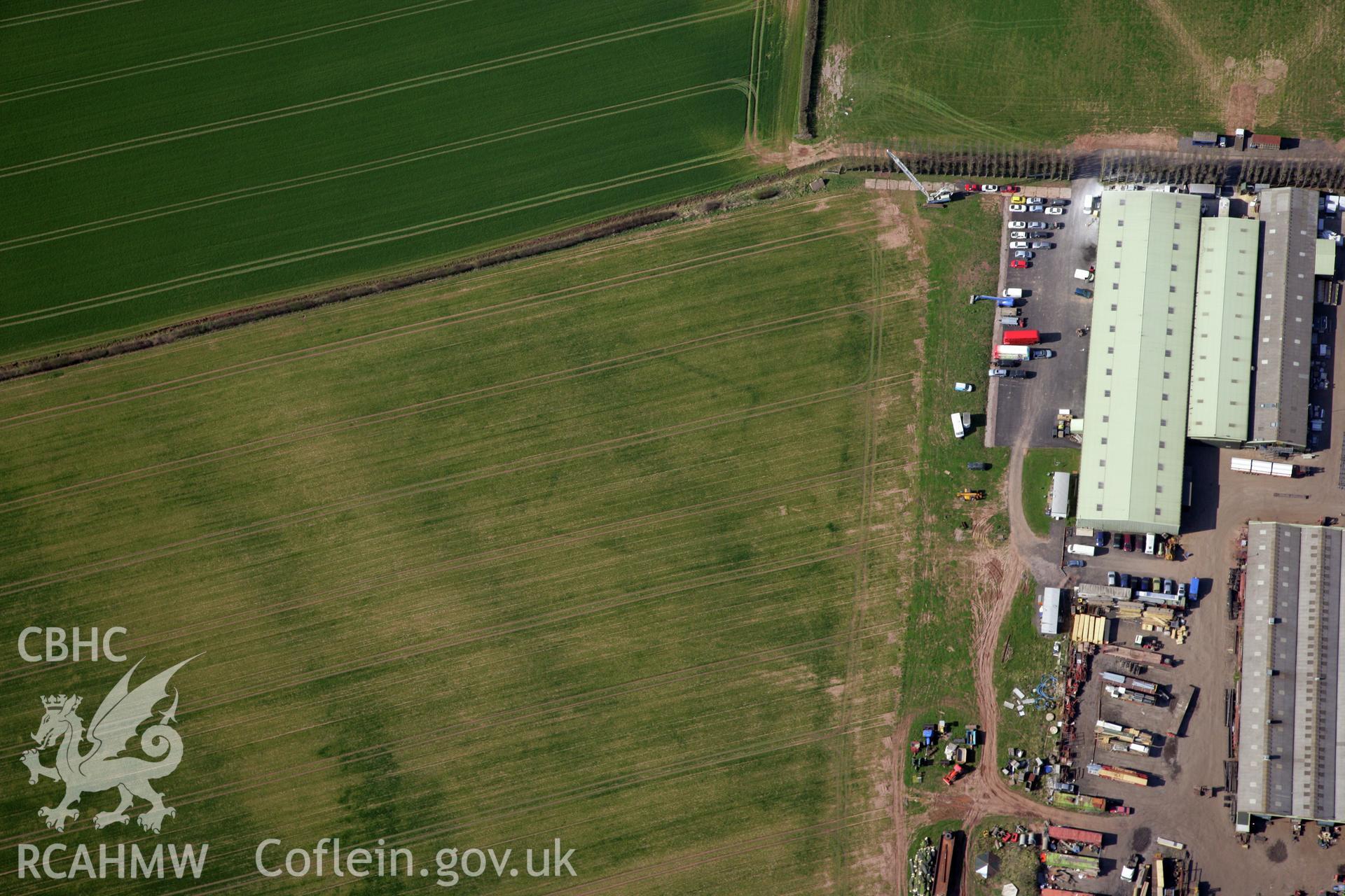 RCAHMW colour oblique photograph of Llancayo Farm defended enclosure cropmarks. Taken by Toby Driver and Oliver Davies on 28/03/2012.