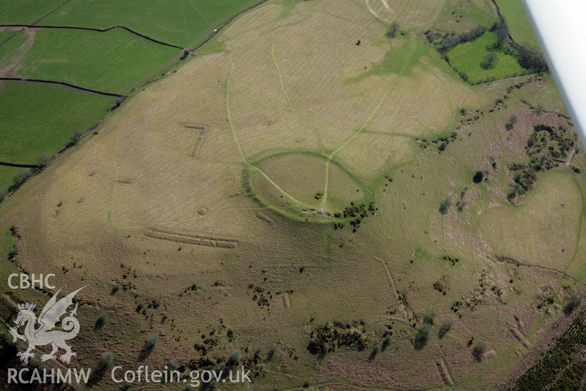 RCAHMW colour oblique photograph of Twyn y Gaer hillfort, and pillow mounds. Taken by Toby Driver and Oliver Davies on 28/03/2012.