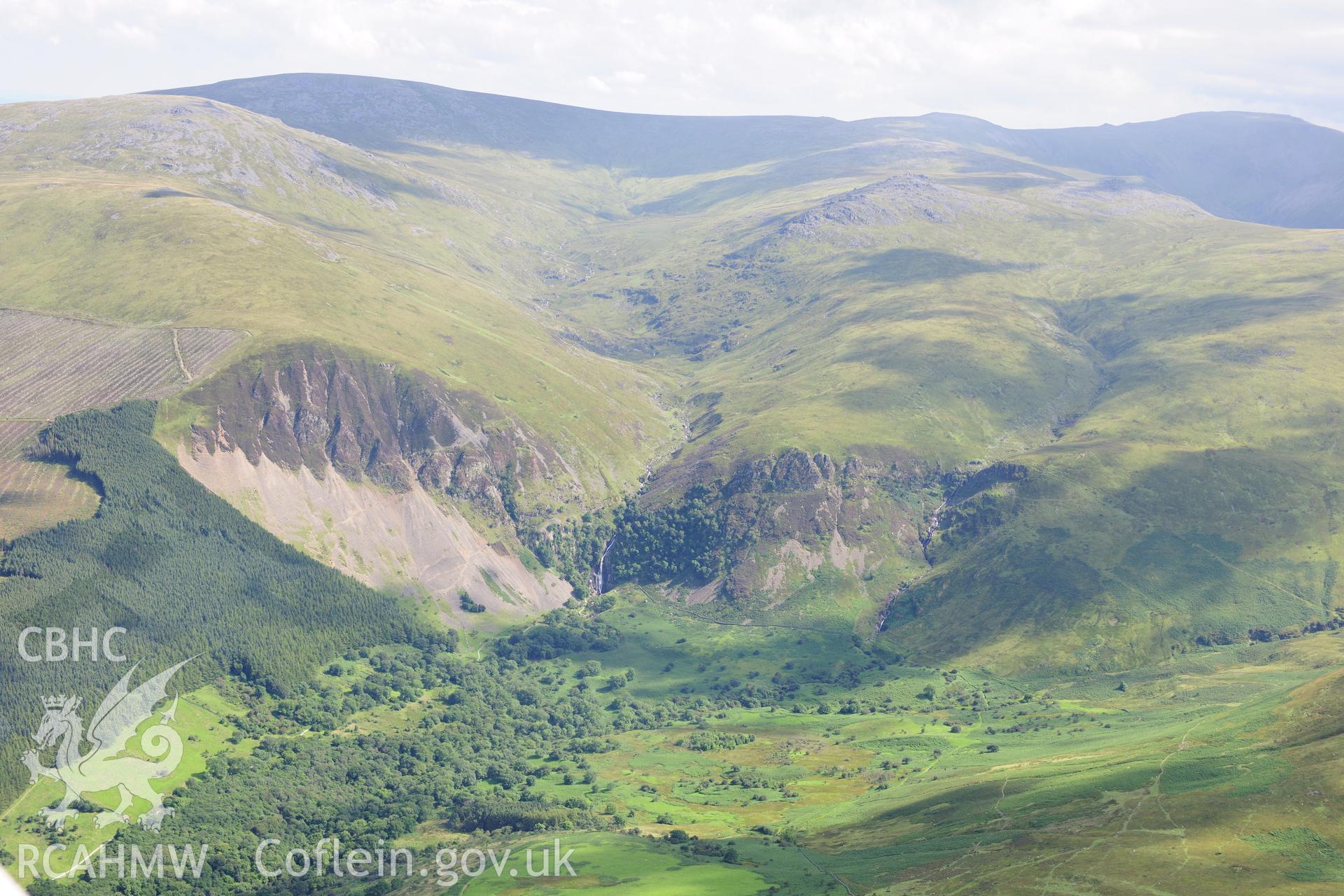 RCAHMW colour oblique photograph of Coedydd Aber National Nature Reserve and Aber Falls, landscape view. Taken by Toby Driver on 10/08/2012.