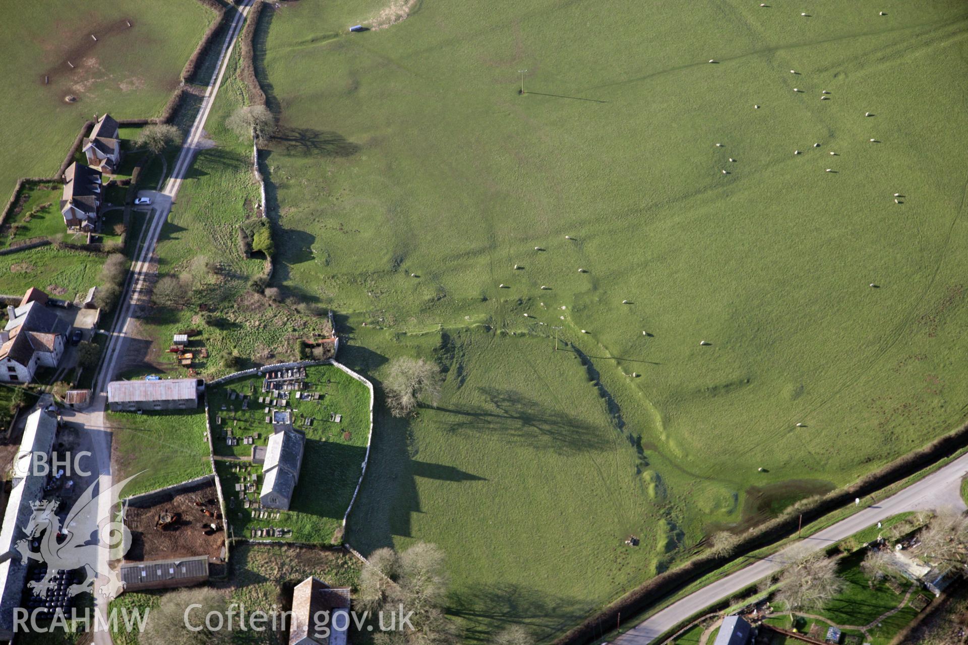 RCAHMW colour oblique photograph of Llanddewi Earthworks. Taken by Toby Driver on 02/02/2012.