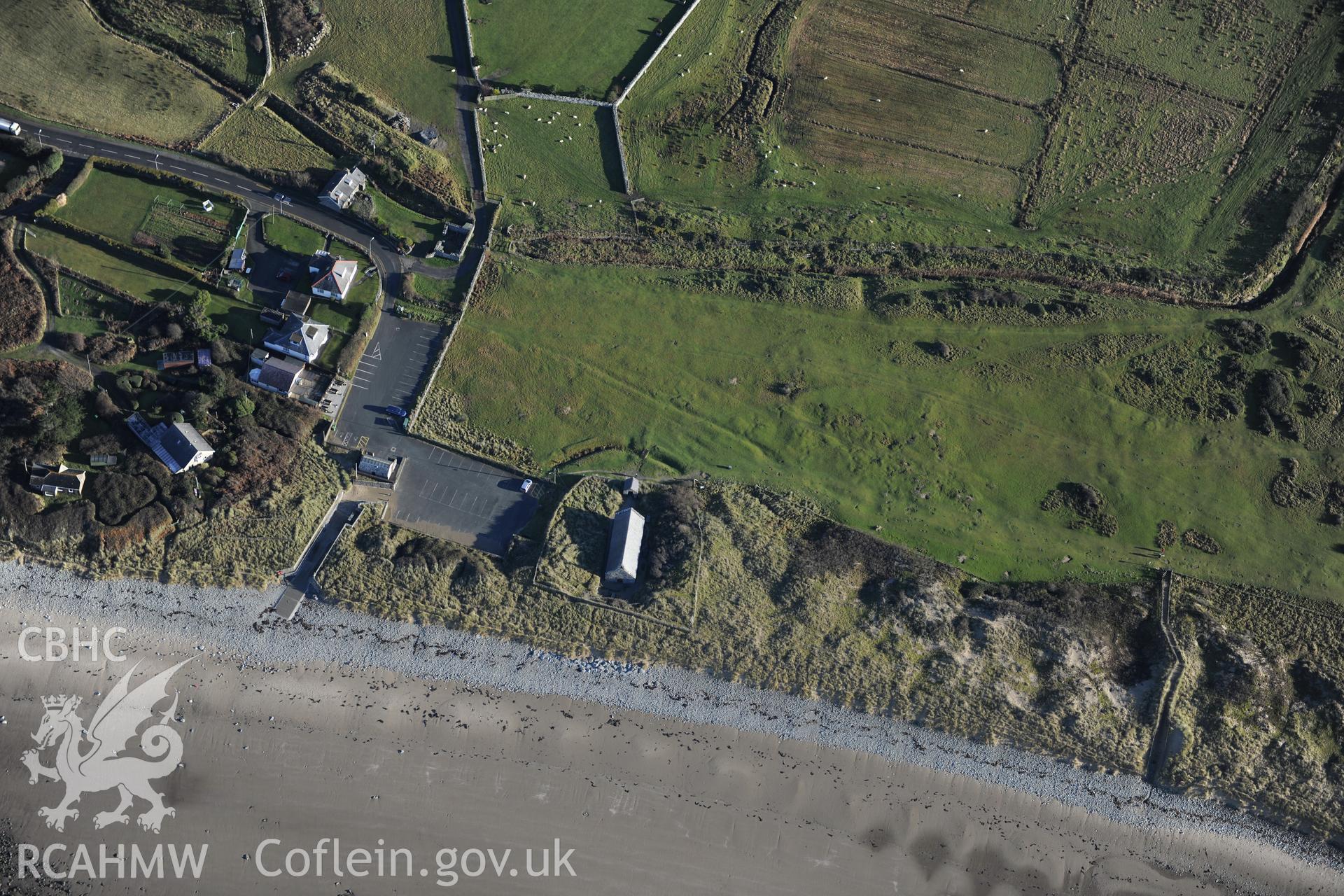 RCAHMW colour oblique photograph of St Tanwg's Church, Llandanwg, with earthworks of outer enclosure. Taken by Toby Driver on 10/12/2012.
