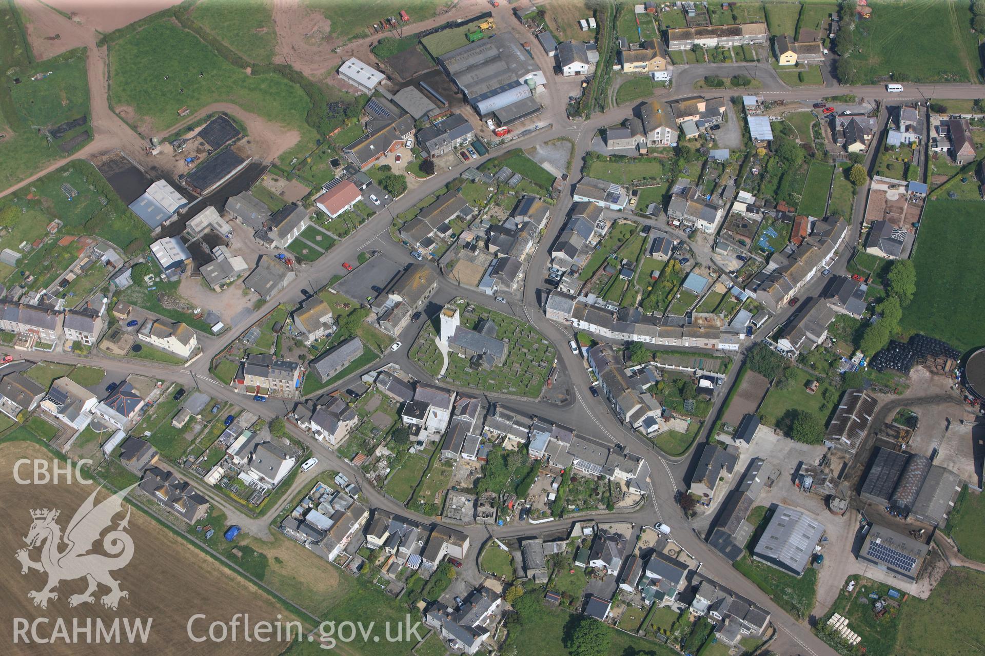 RCAHMW colour oblique photograph of General view of All Saints Church and Llansaint village, looking north west. Taken by Toby Driver on 24/05/2012.
