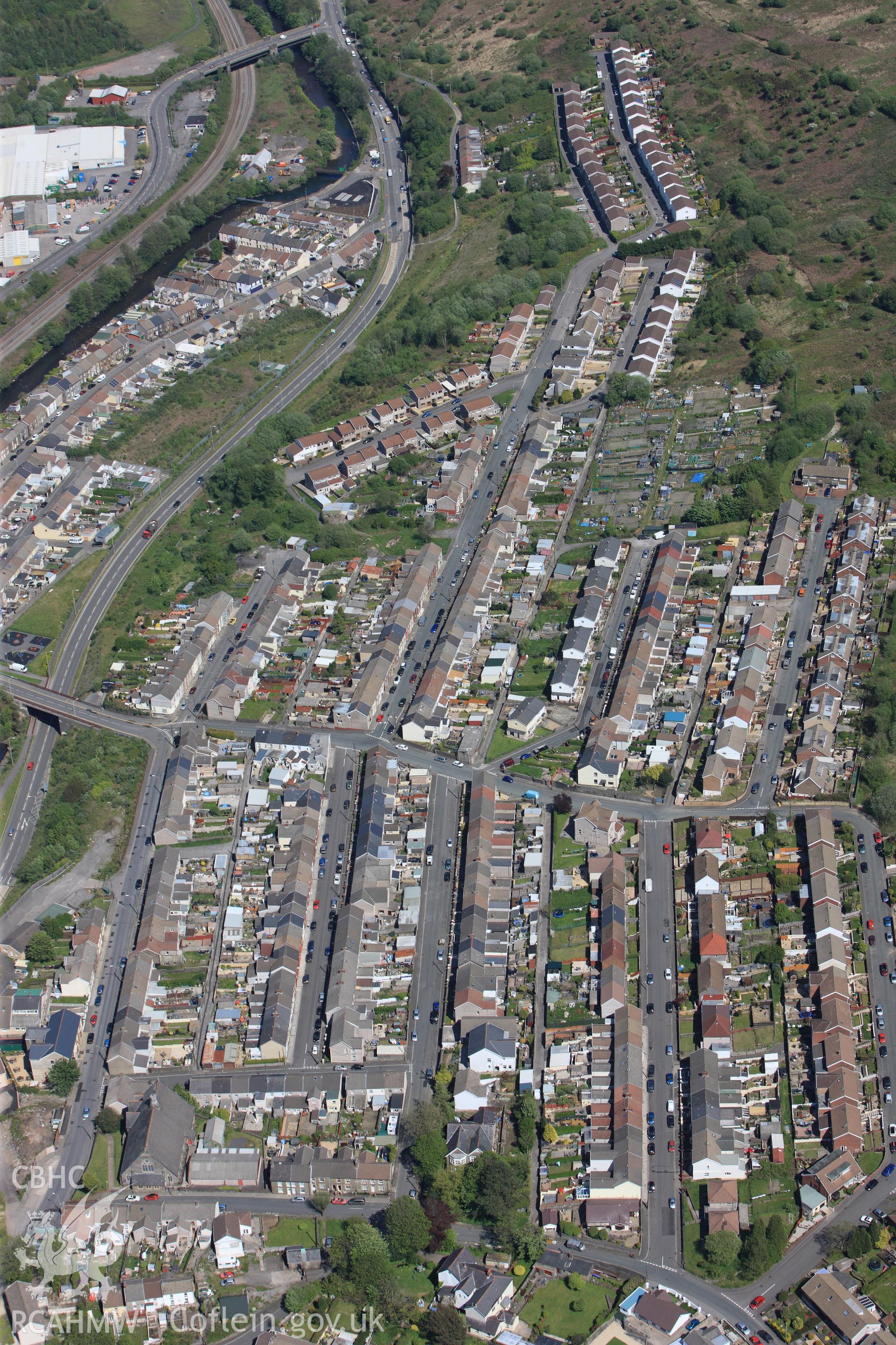 RCAHMW colour oblique photograph of Cymmer, St John's Church and terraced housing, from west. Taken by Toby Driver on 22/05/2012.