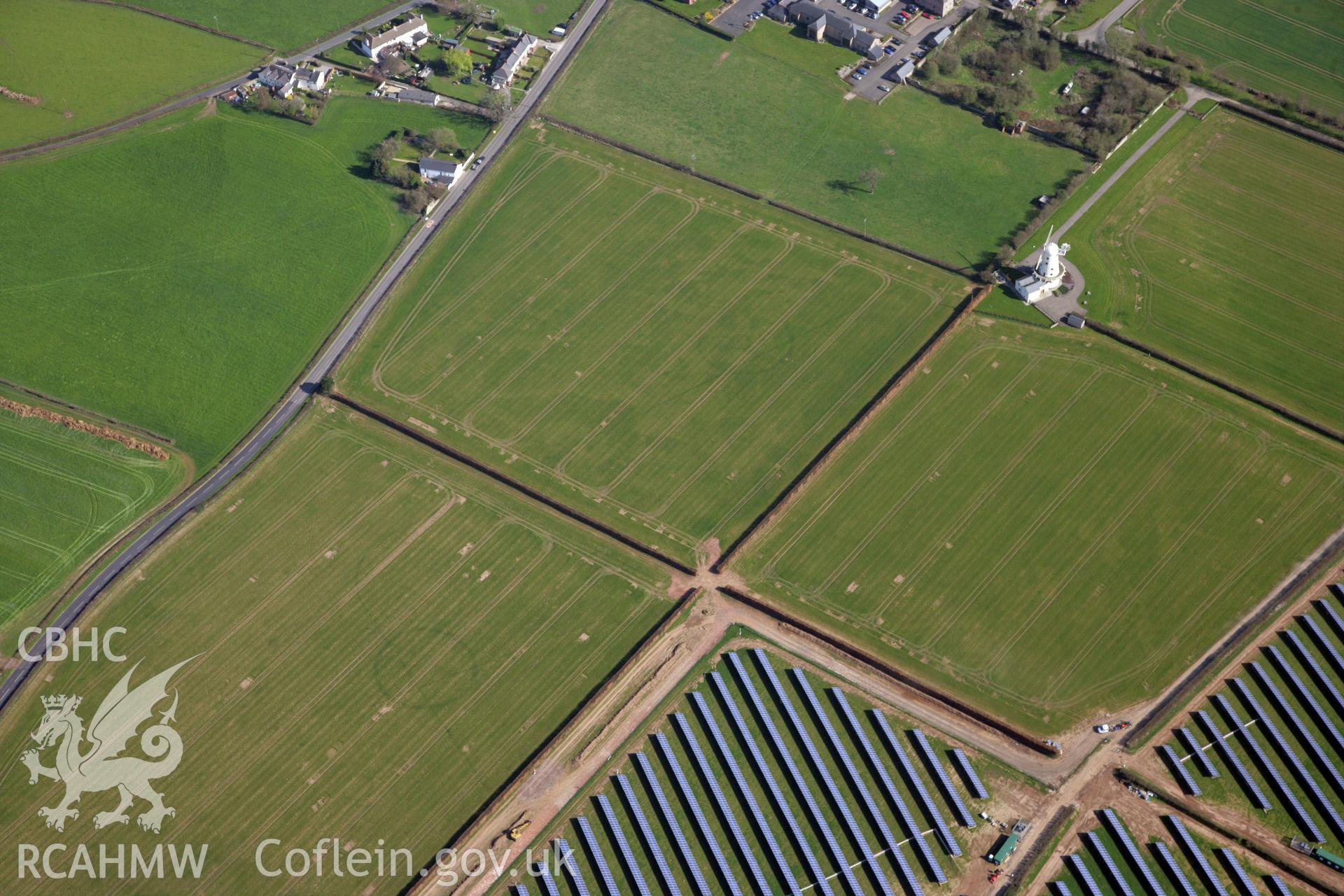 RCAHMW colour oblique photograph of Llancayo Farm Roman marching camp, and site of temple; cropmarks showing east side of camp and barrow cemetery. Taken by Toby Driver and Oliver Davies on 28/03/2012.