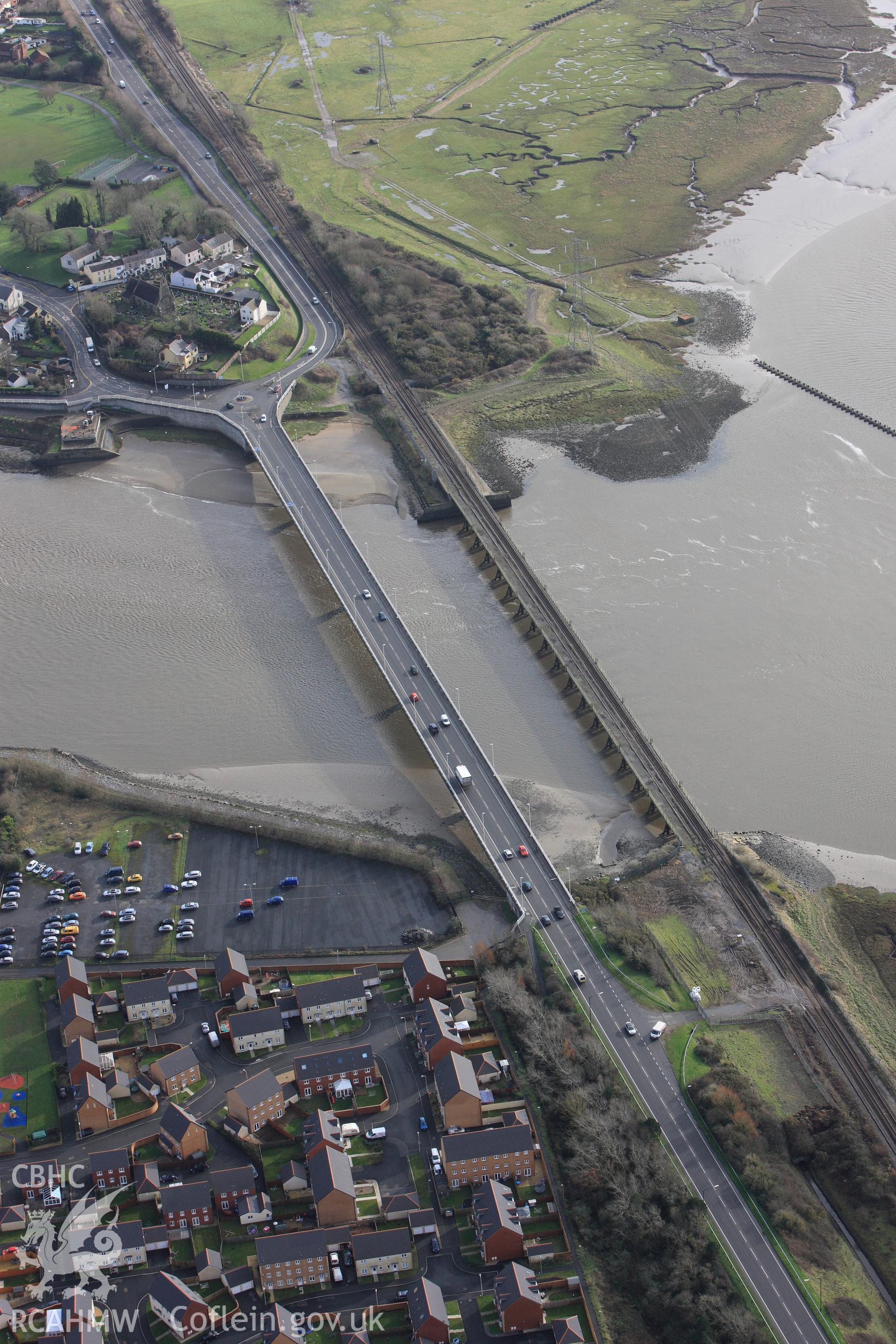 RCAHMW colour oblique photograph of Loughor Railway Viaduct, with St. Michael's Church. Taken by Toby Driver on 27/01/2012.
