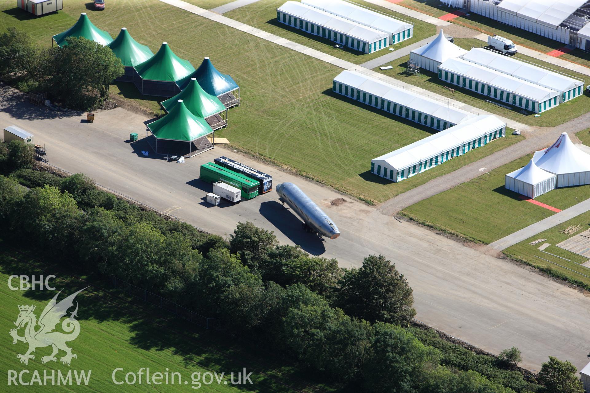 RCAHMW colour oblique photograph of Llandow Airfield, site of the 2012 National Eisteddfod of Wales, showing aircraft fuselage exhibit/theatre. Taken by Toby Driver on 24/07/2012.