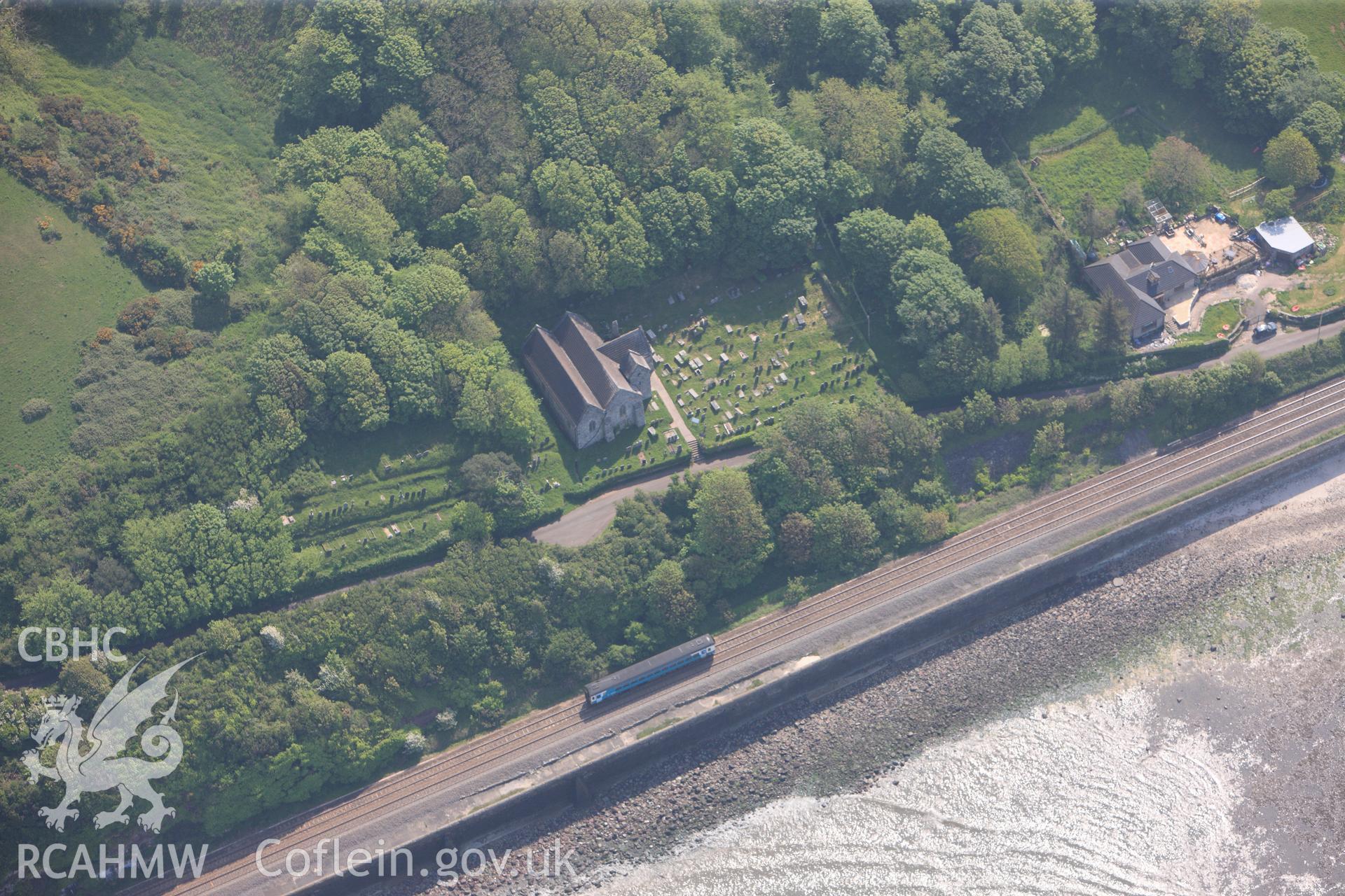 RCAHMW colour oblique photograph of General view of St Ishmael's Church, looking south east. Taken by Toby Driver on 24/05/2012.