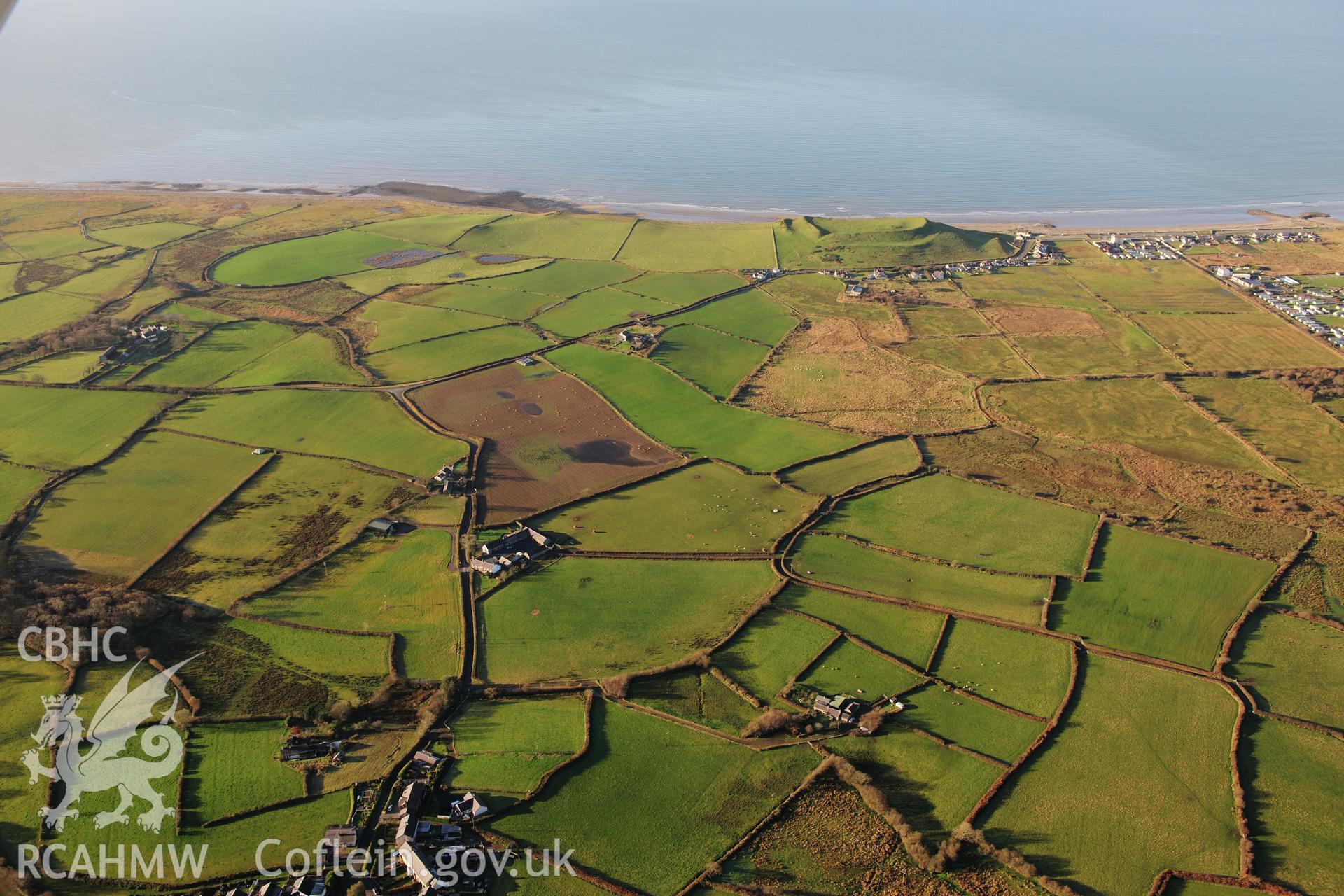 RCAHMW colour oblique photograph of Dinas Dinlle hillfort, wide view. Taken by Toby Driver on 10/12/2012.